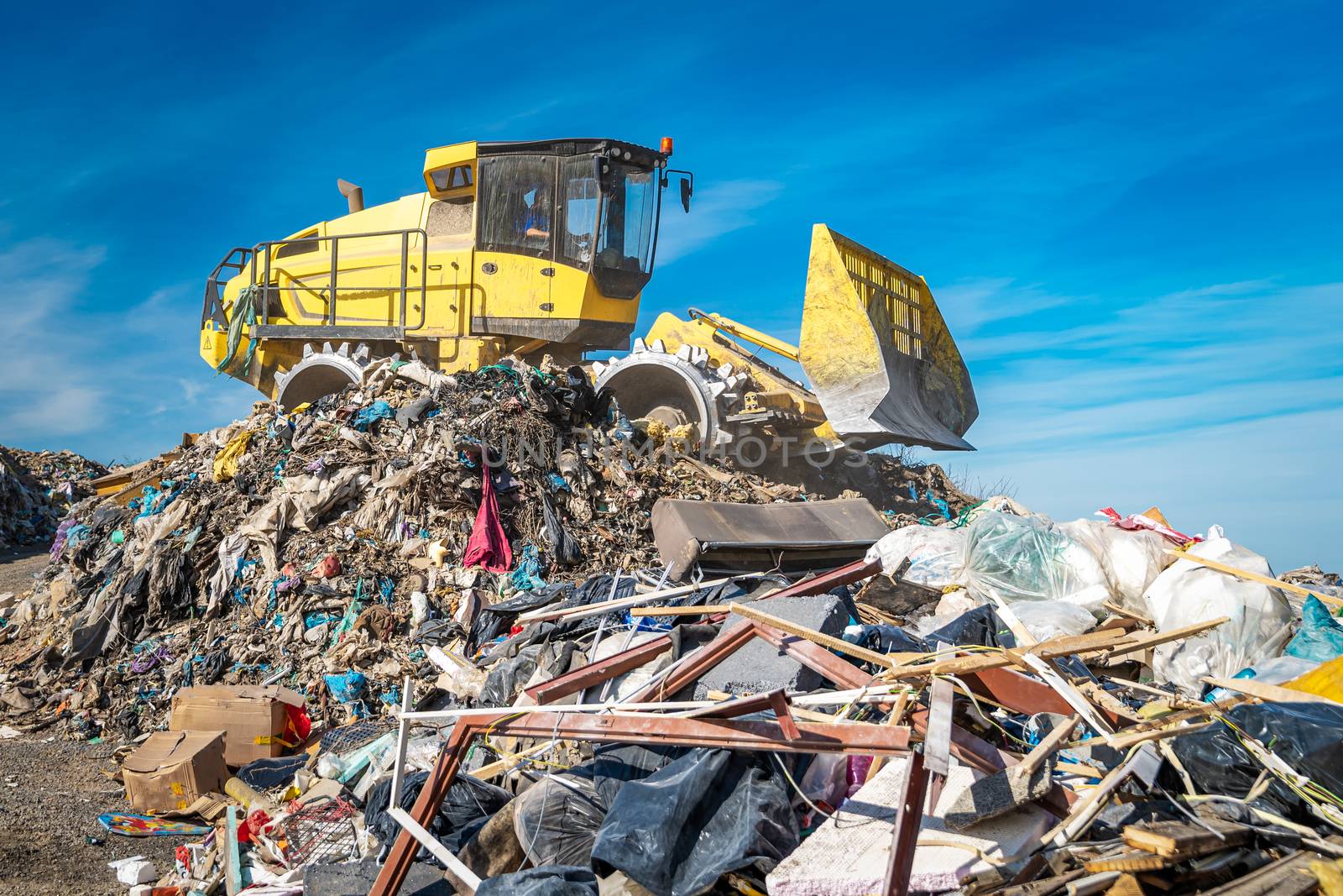 compactor at a landfill processing municipal waste.