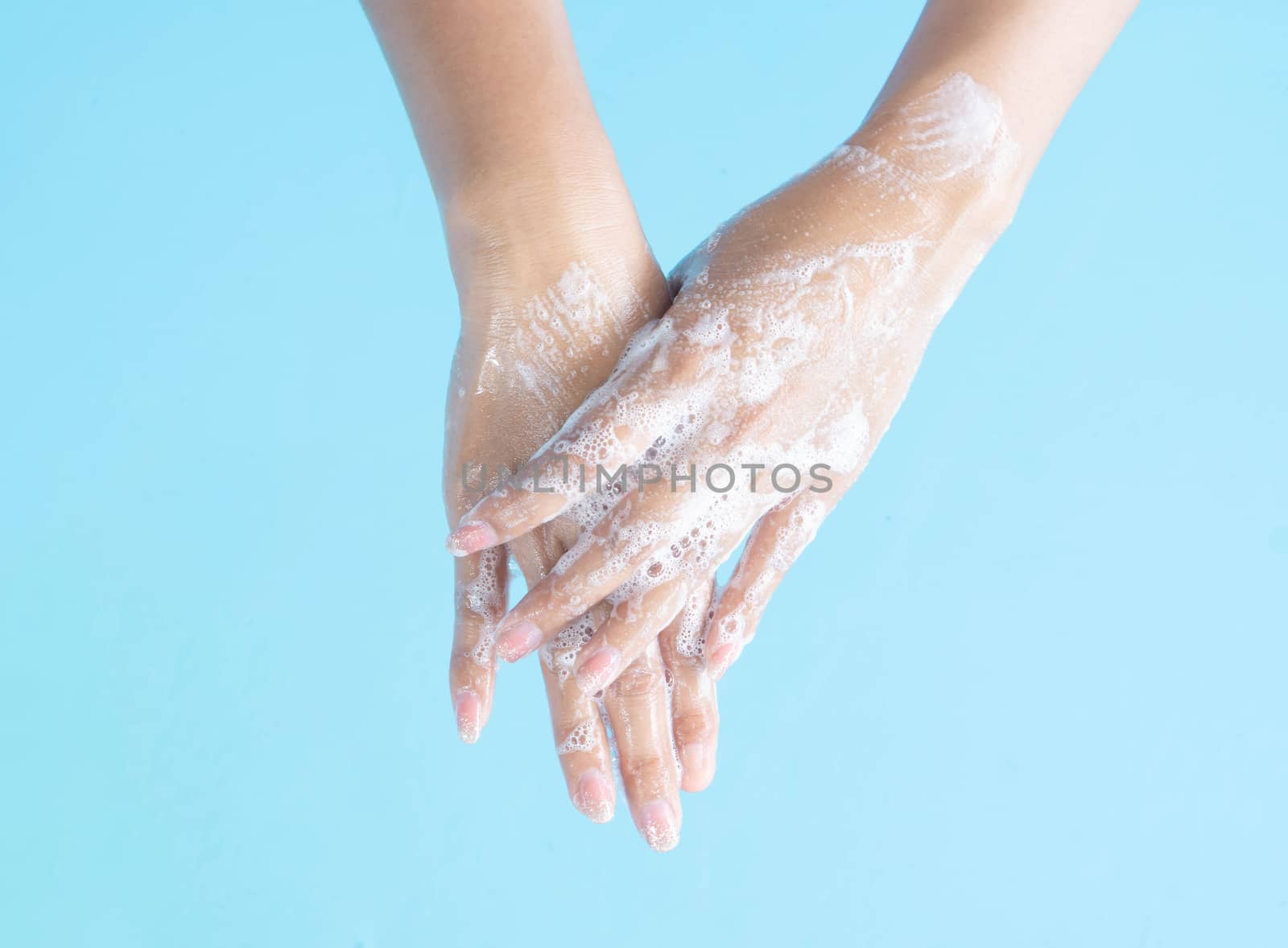 Closeup woman's hand washing with soap on blue background, healt by pt.pongsak@gmail.com