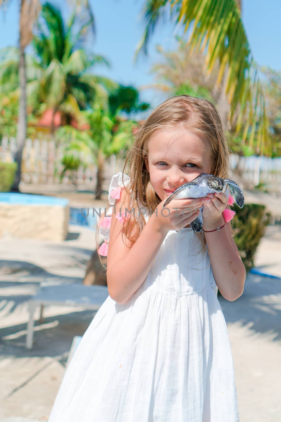 Adorable little girl with a small turtle in her hands in the natural reserve by travnikovstudio
