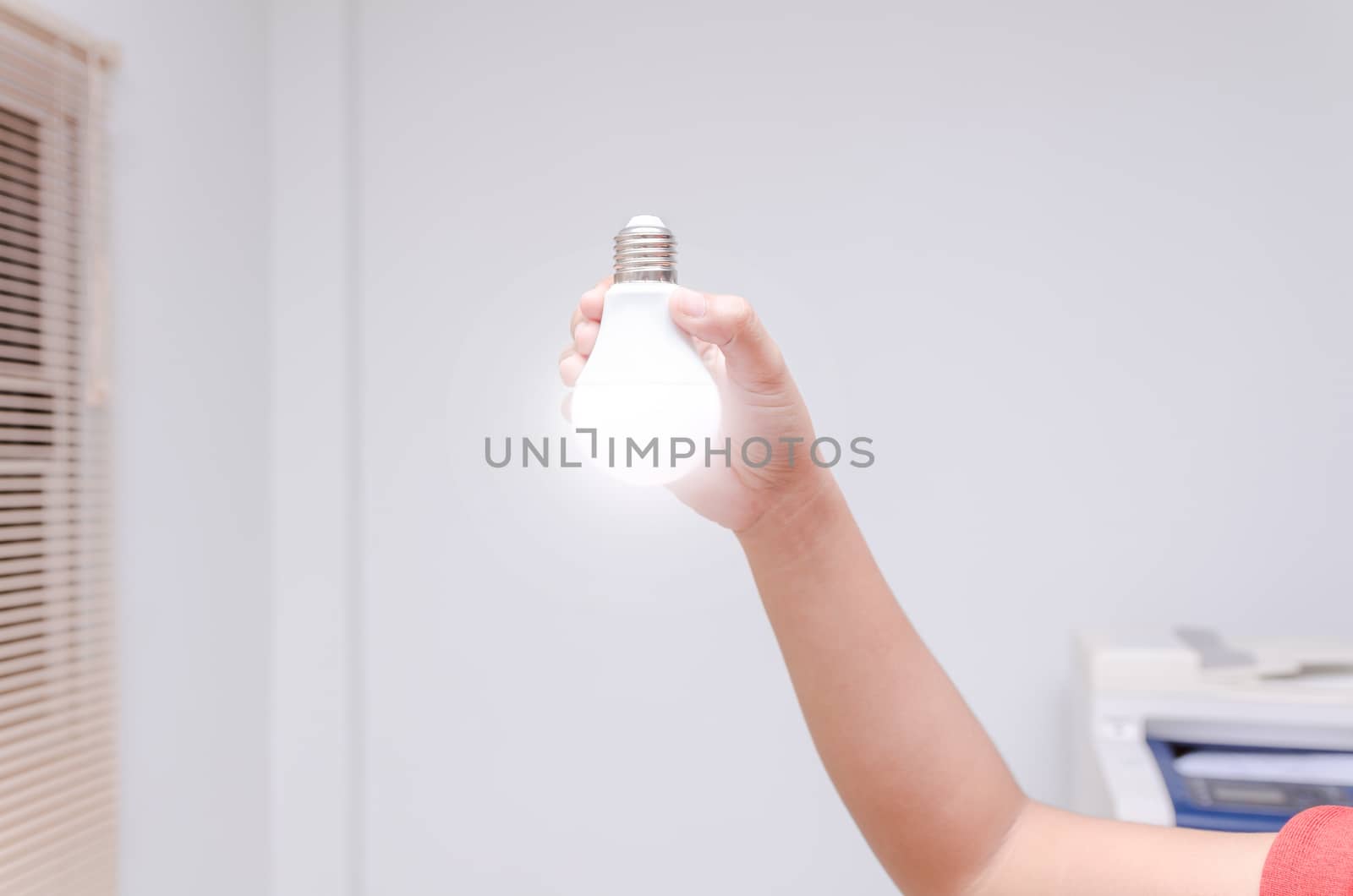 Woman hand holding LED bulb