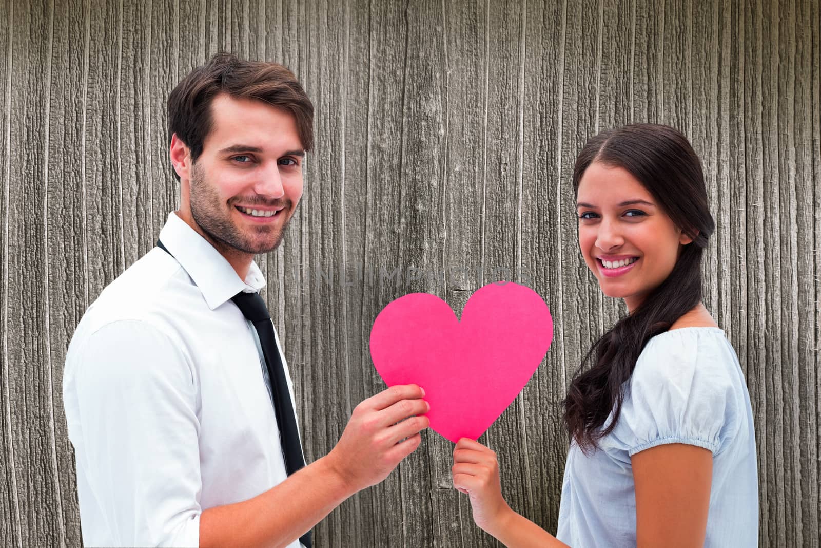 Pretty brunette giving boyfriend her heart against wooden planks