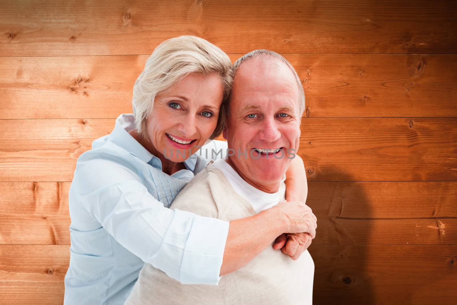 Composite image of happy mature couple smiling at camera by Wavebreakmedia