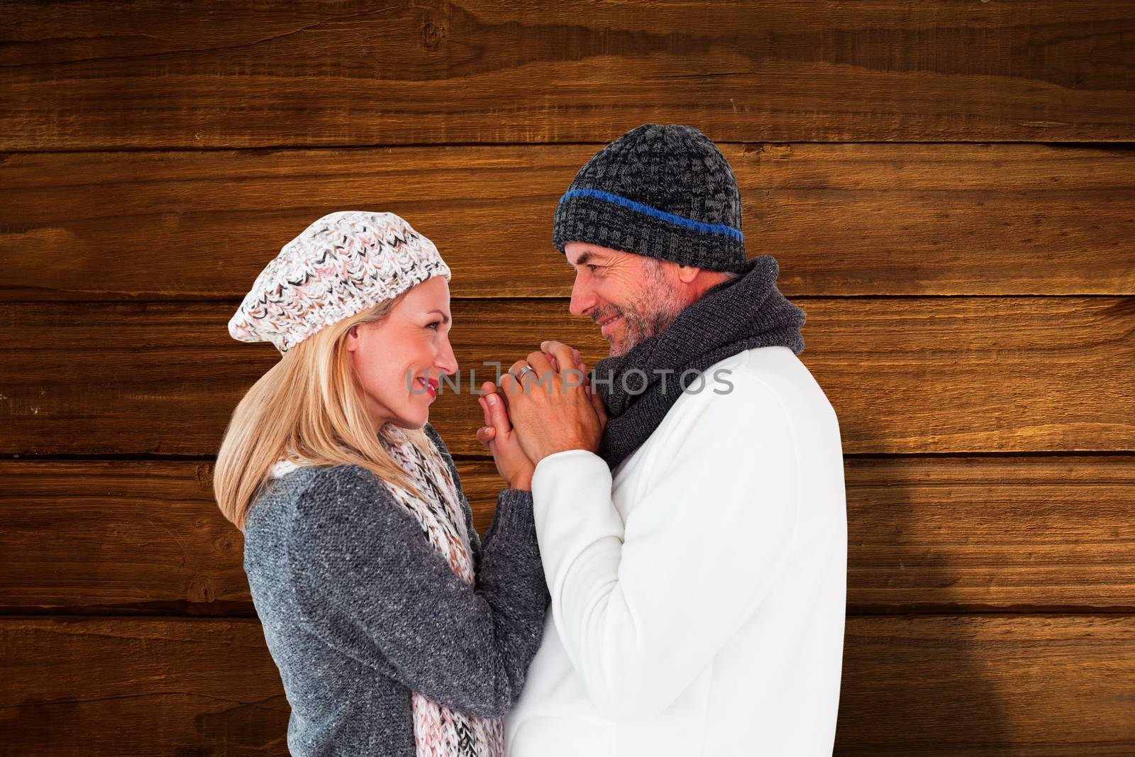 Composite image of couple in winter fashion embracing by Wavebreakmedia