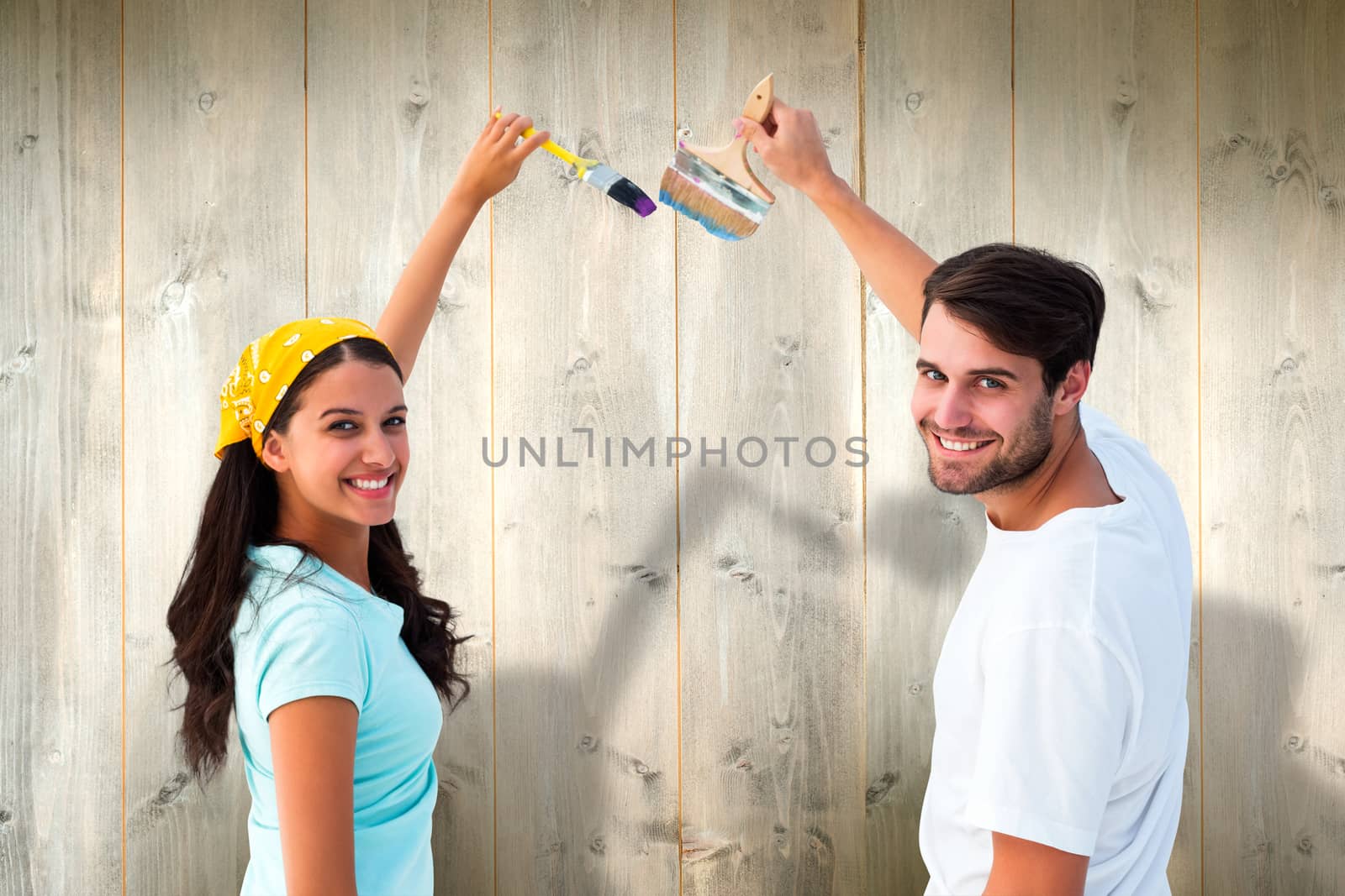 Composite image of happy young couple painting together by Wavebreakmedia