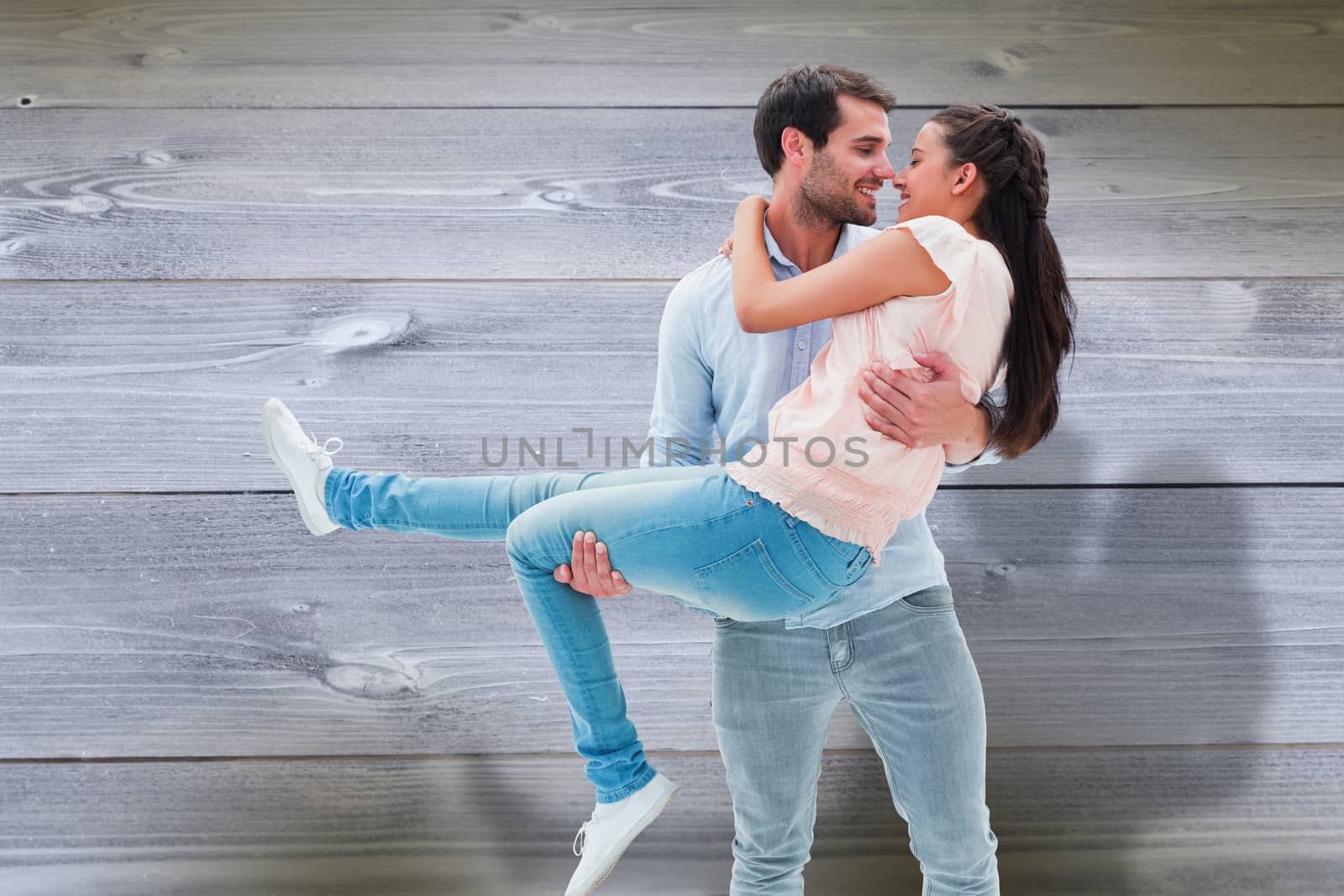 Attractive young couple having fun against bleached wooden planks background