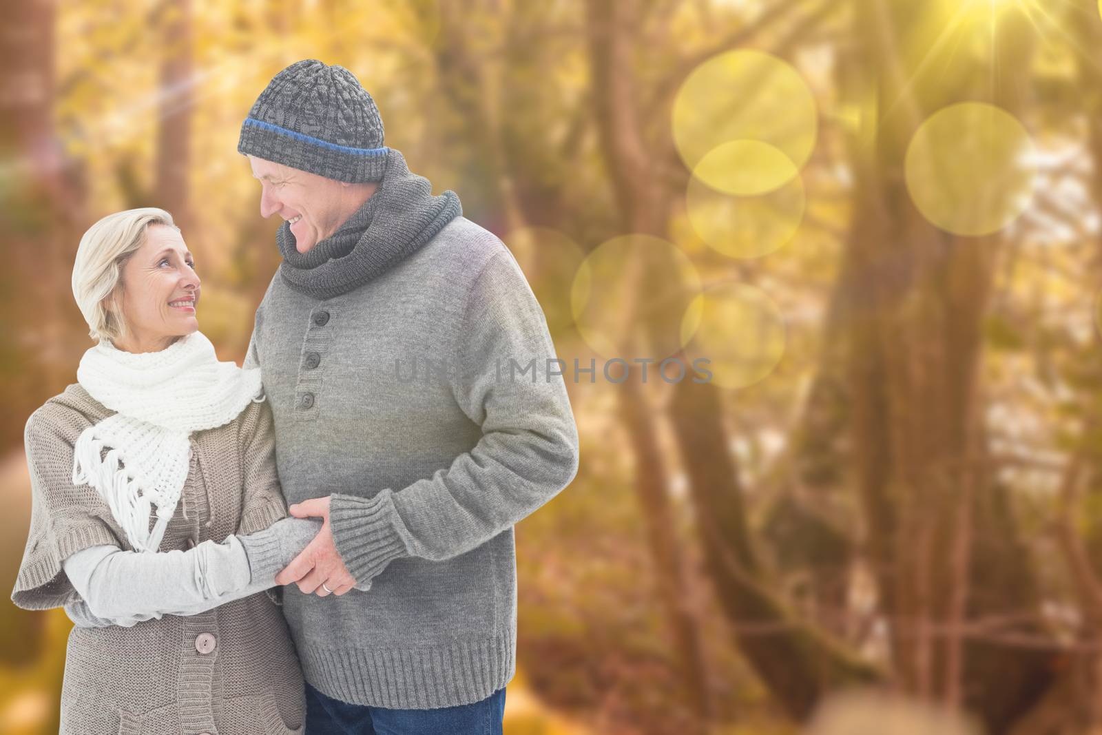 Mature winter couple against tranquil autumn scene in forest