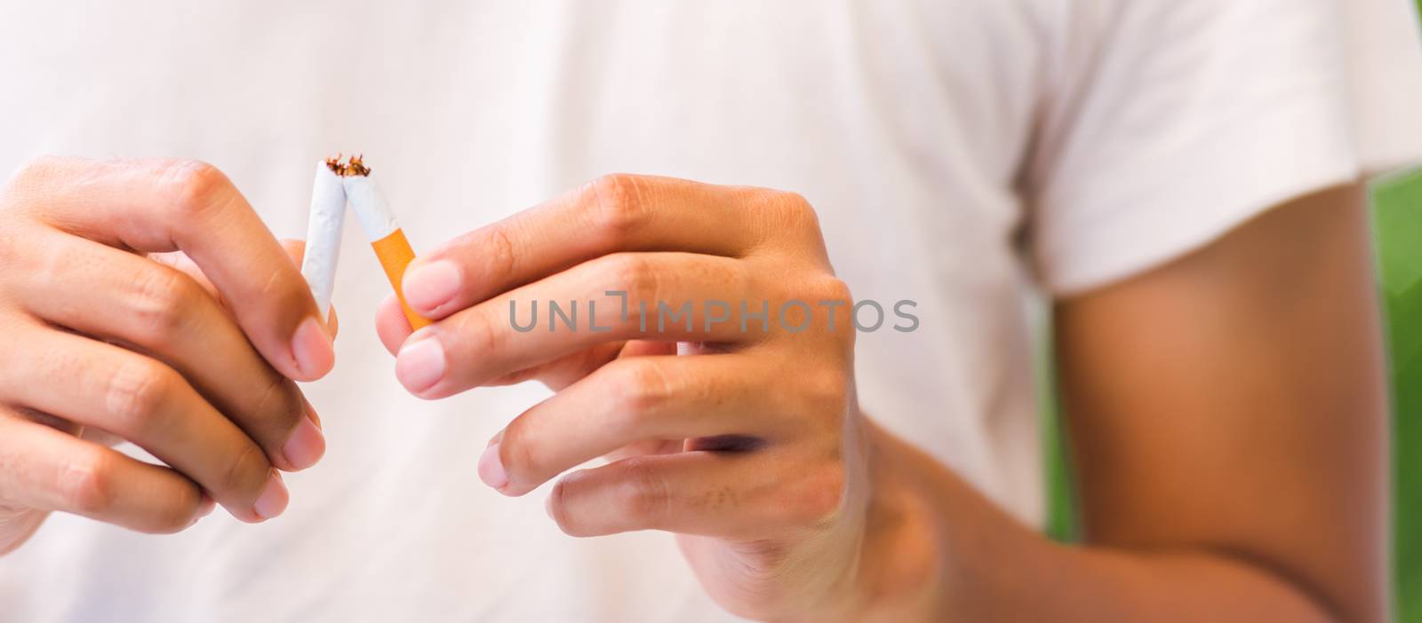 The man use hands breaking down cigarettes by Sorapop