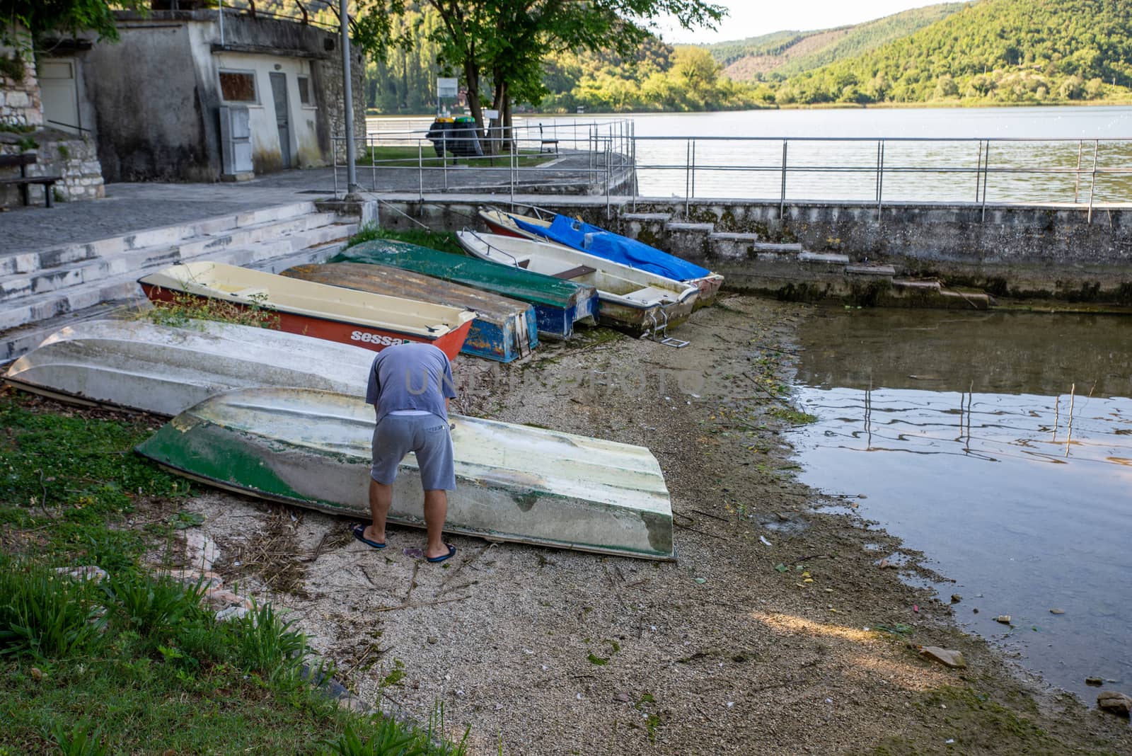 piediluco, italia 25 maggio 2020:man who is doing maintenance on a boat