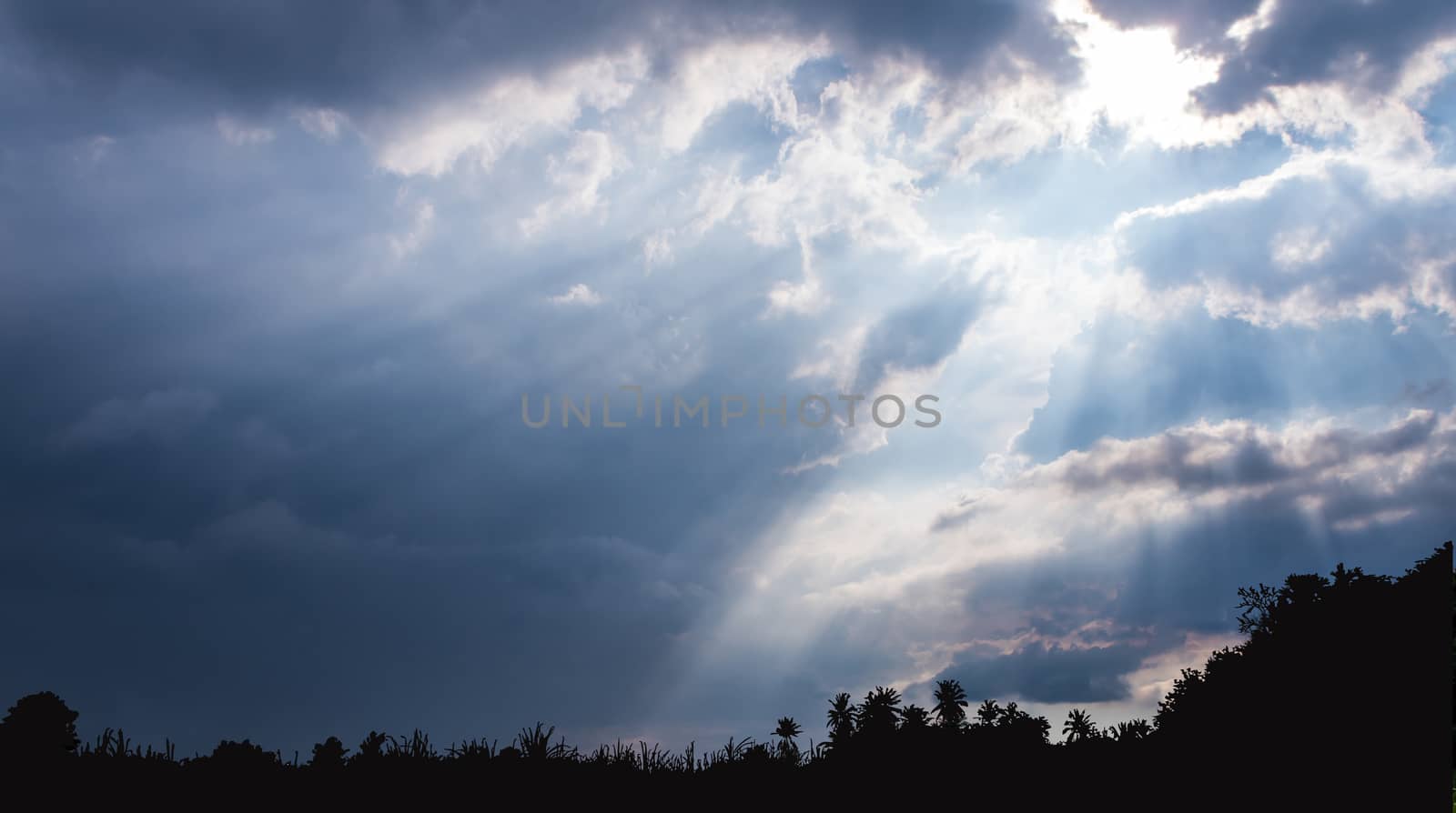 Beam of Sunlight behind dark clouds in the countryside