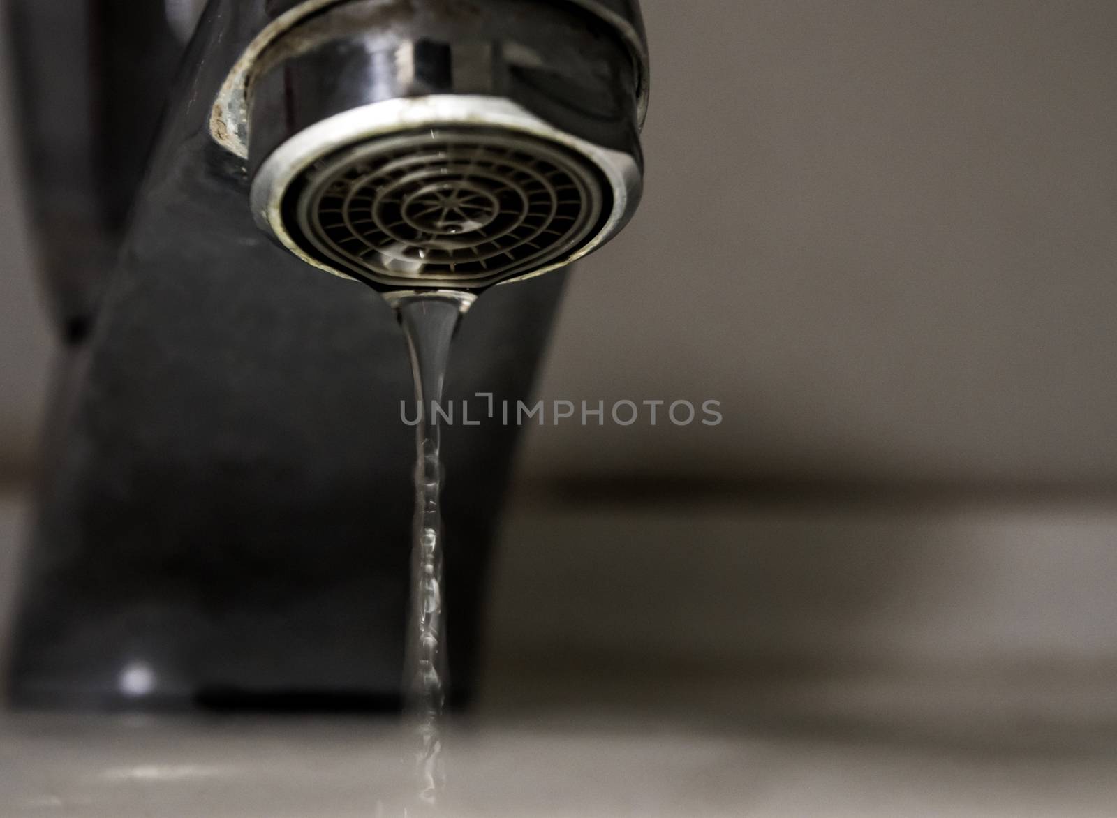 Leaking water drops from old rust and stained faucet, Save water concept old tap