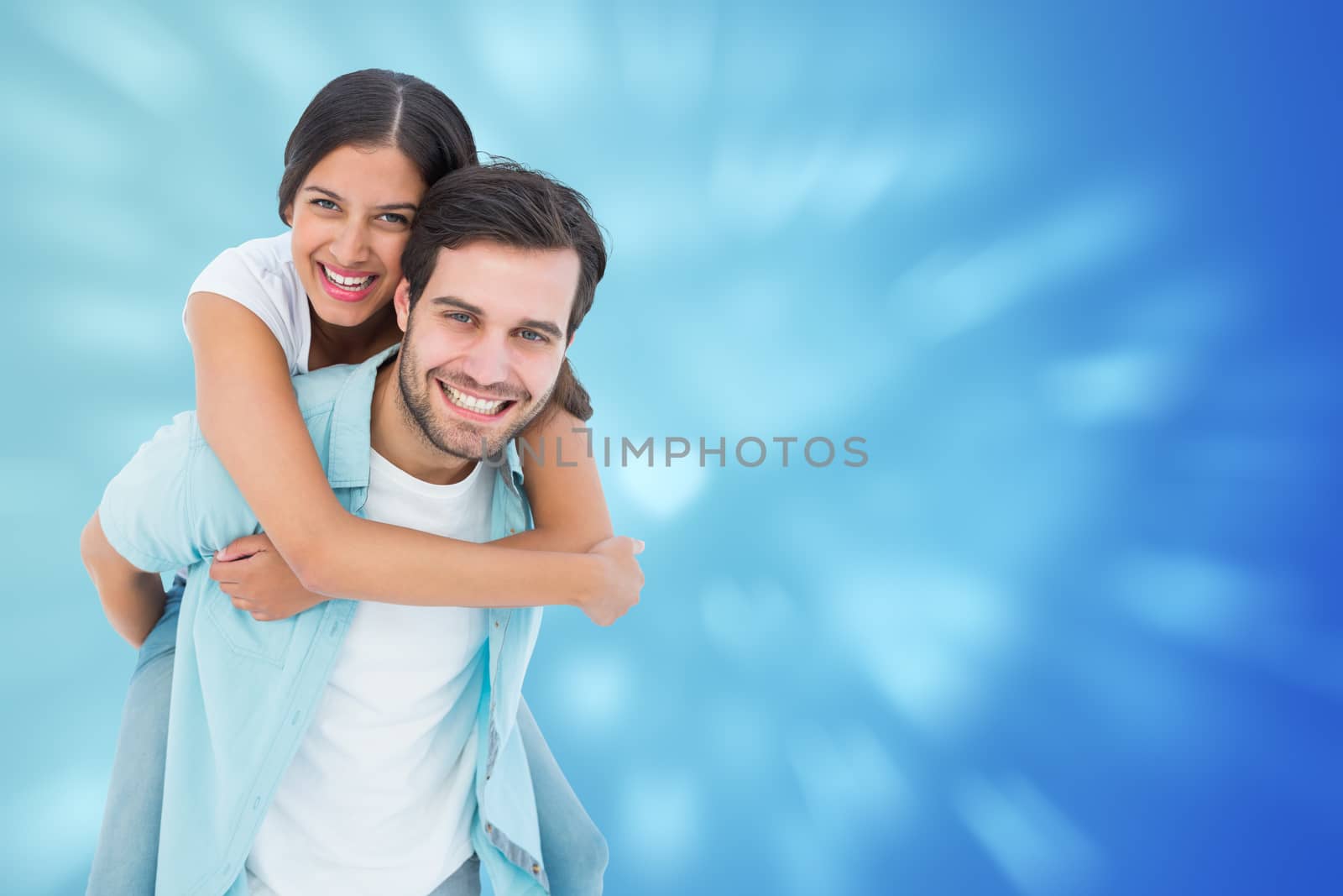 Happy casual man giving pretty girlfriend piggy back against valentines heart design