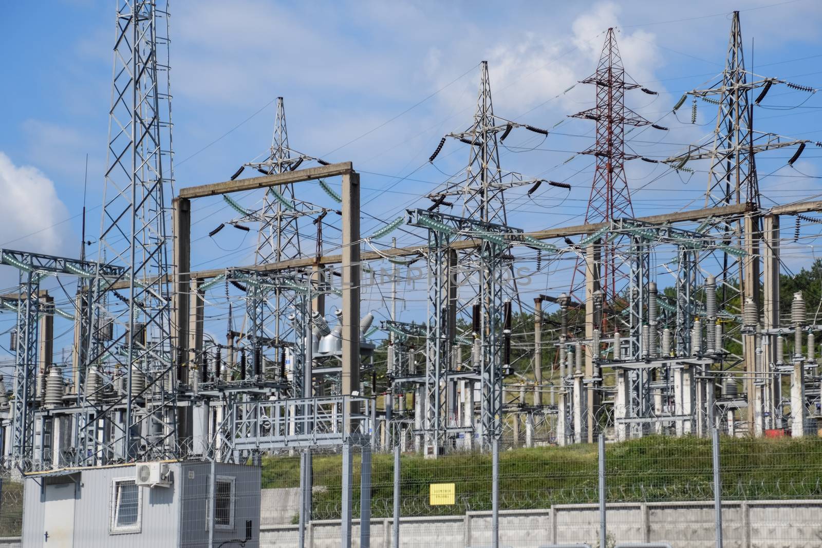 a Power substation equipment, transformers and wire poles.
