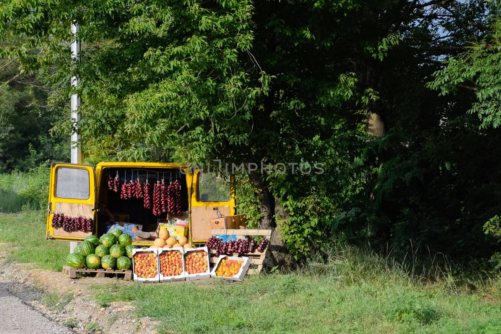 Selling vegetables and watermelons by the road. Resort shops by the road for tourists.