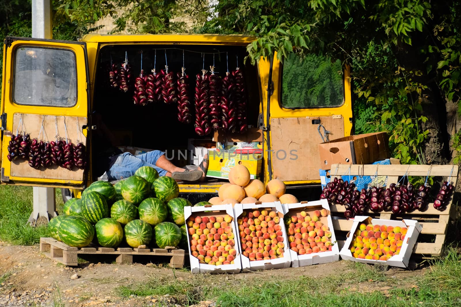 Selling vegetables and watermelons by the road. Resort shops by the road for tourists.