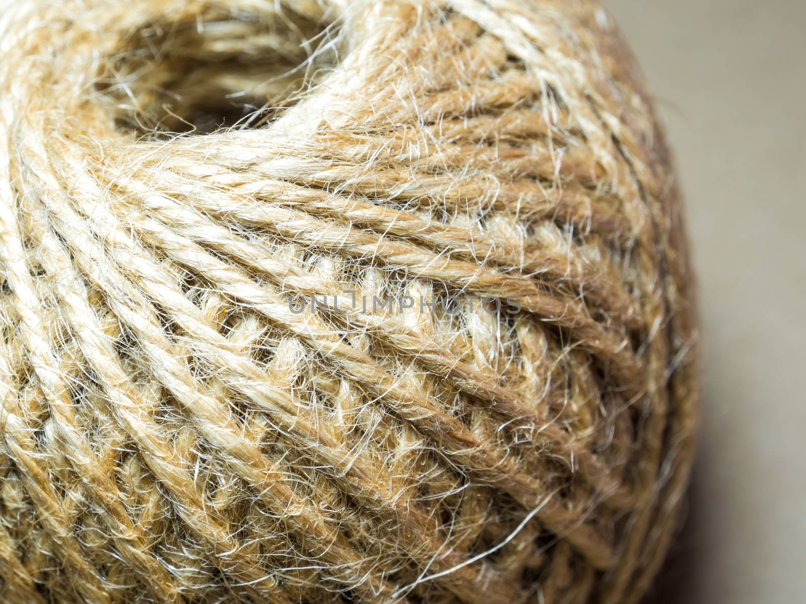 Texture of the brown natural rustic hemp cord in roll on kraft paper texture background