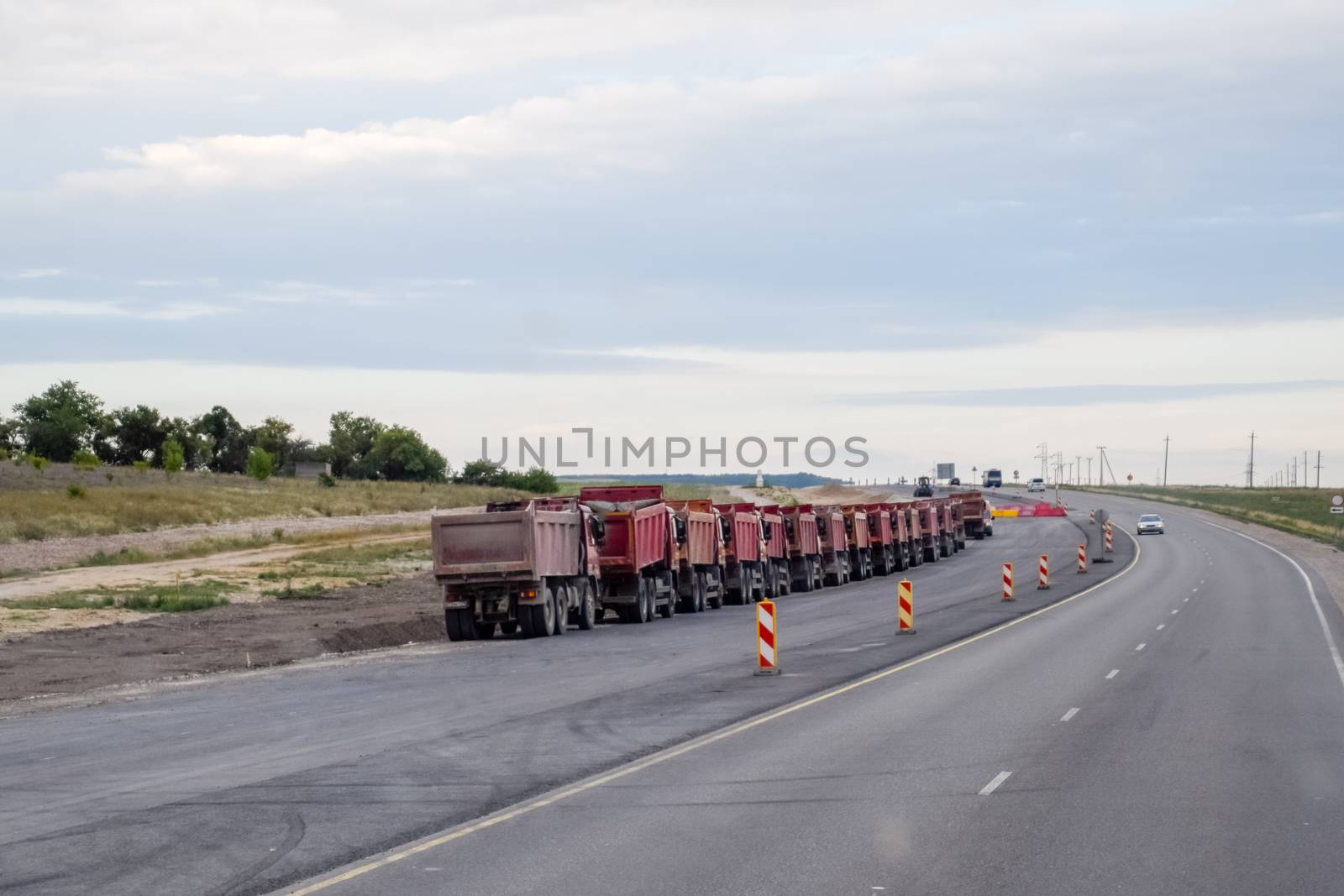 Tipper trucks are standing on the side of the road. Crimean peninsula.