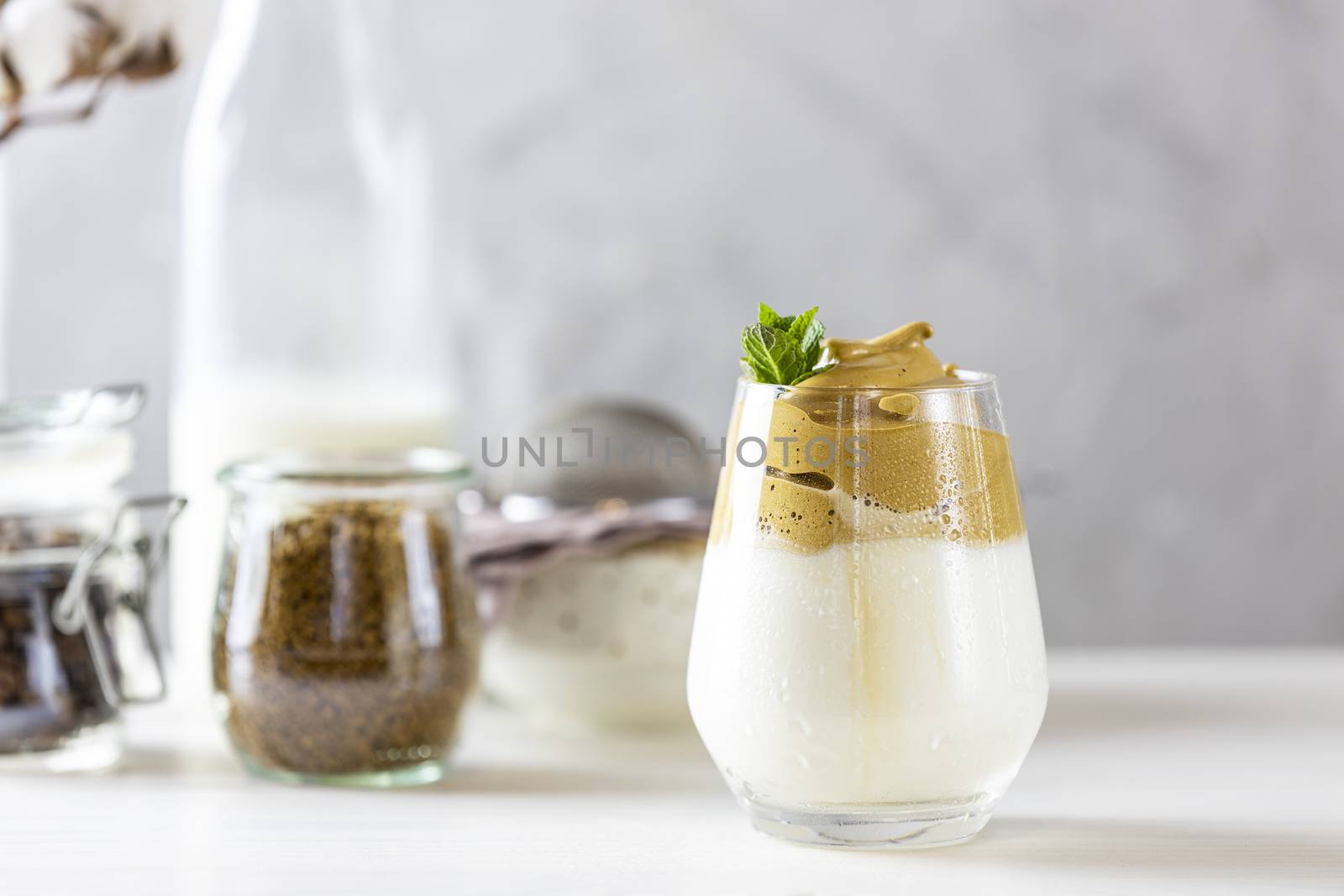 Glass of Iced Dalgona Coffee, a trendy fluffy creamy whipped cof by ArtSvitlyna