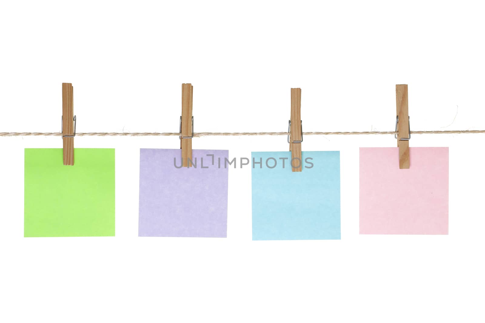 Four colored reminder notes on string line with pegs