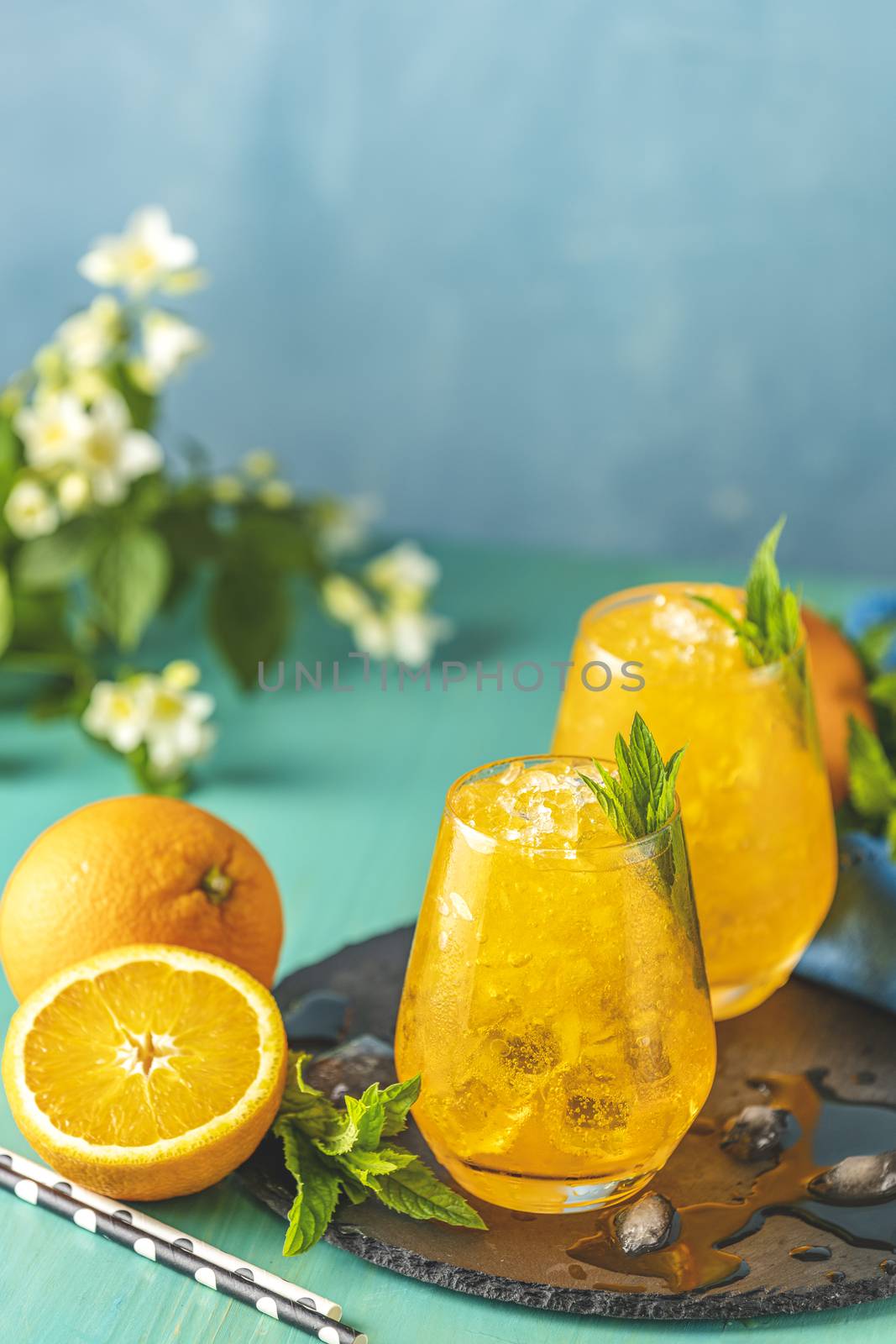 Orange drink with ice. Two glass of orange ice drink with fresh  by ArtSvitlyna