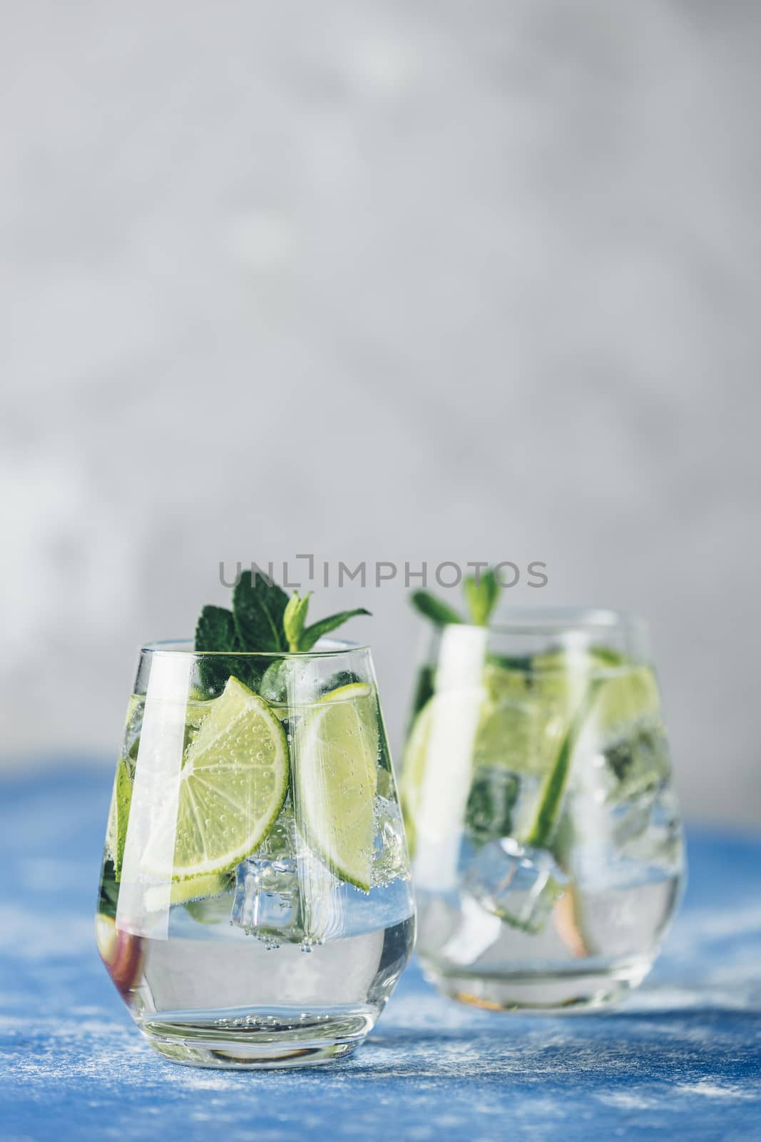 Two detox water, mojito or martini tonic cocktail with kiwi, lim by ArtSvitlyna