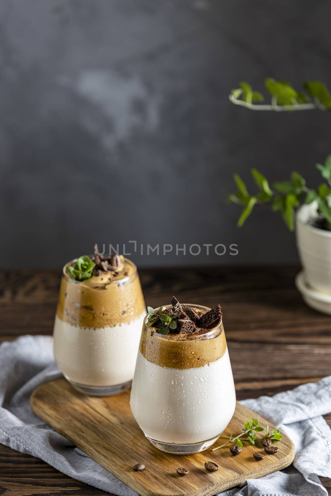 Two glasses of Iced Dalgona Coffee, a trendy fluffy creamy whipp by ArtSvitlyna