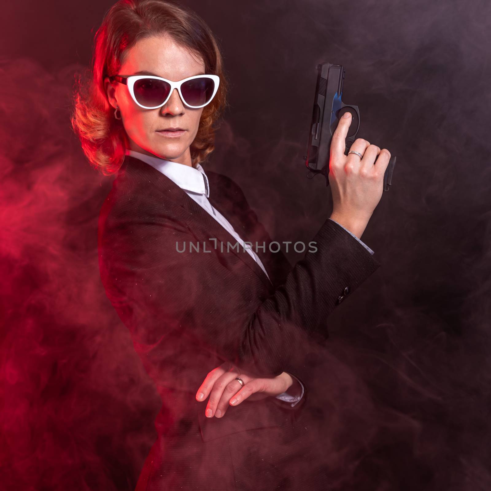 security services agent with a gun in his hand and sun glasses on the eyes by Edophoto