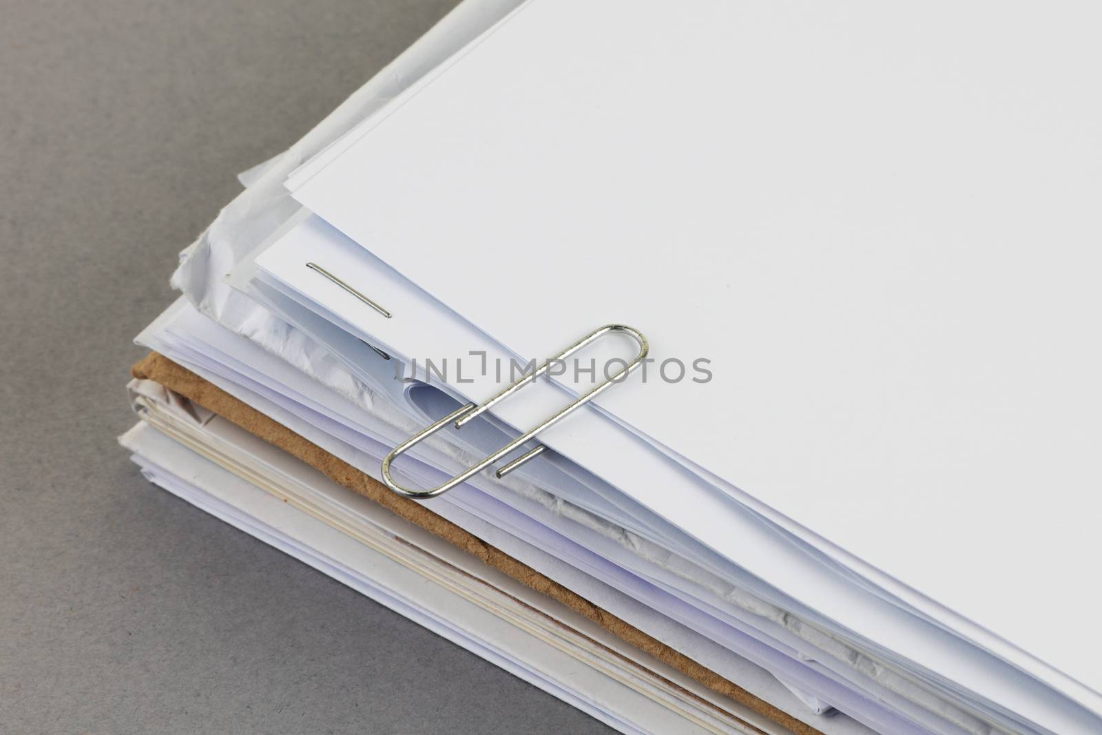 A bundle of work papers with paper clip