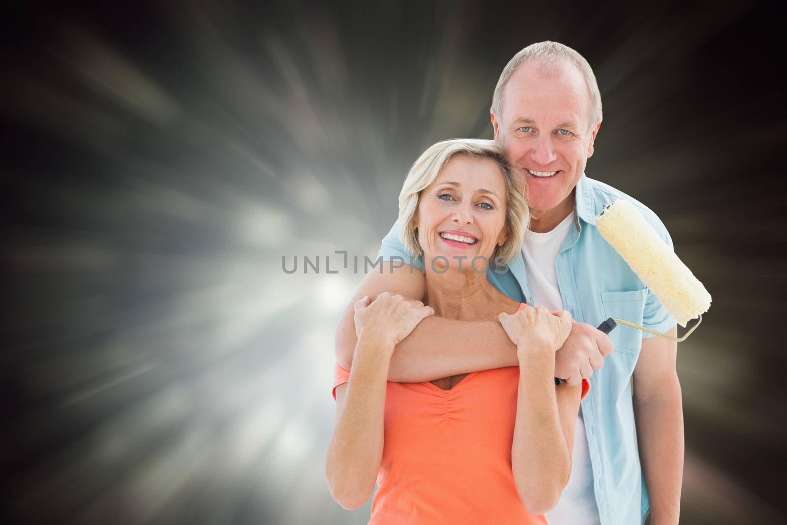 Composite image of happy older couple holding paint roller by Wavebreakmedia