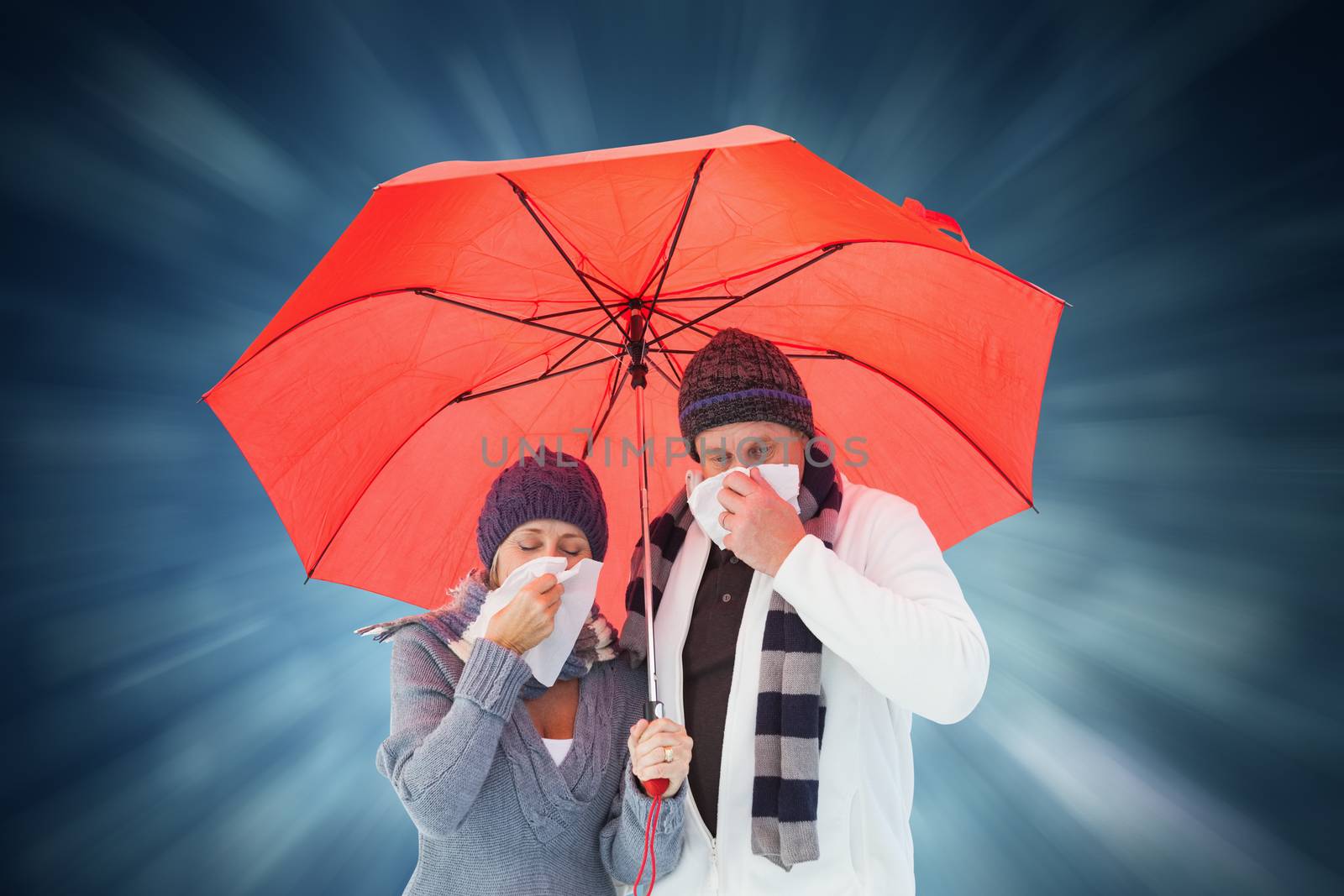 Mature couple blowing their noses under umbrella against blue abstract light spot design
