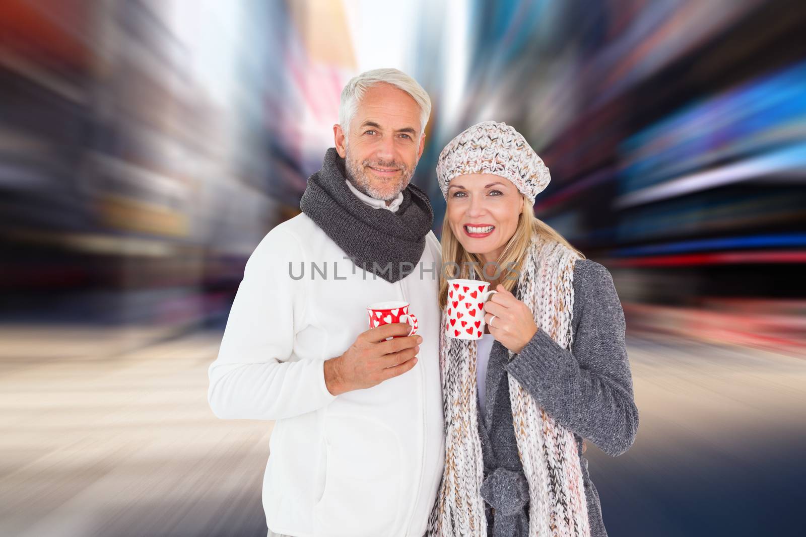 Happy couple in winter fashion holding mugs against blurry new york street