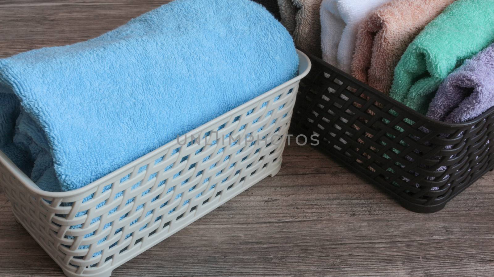 colorful towels in a basket on a wooden table