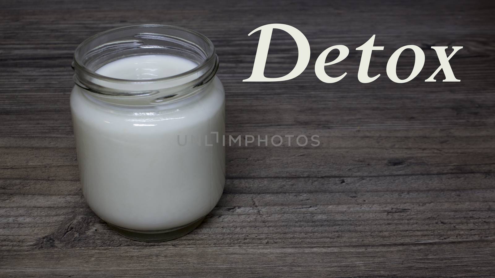 Greek yogurt, milk in a glass jar on a wooden table, detox, diet