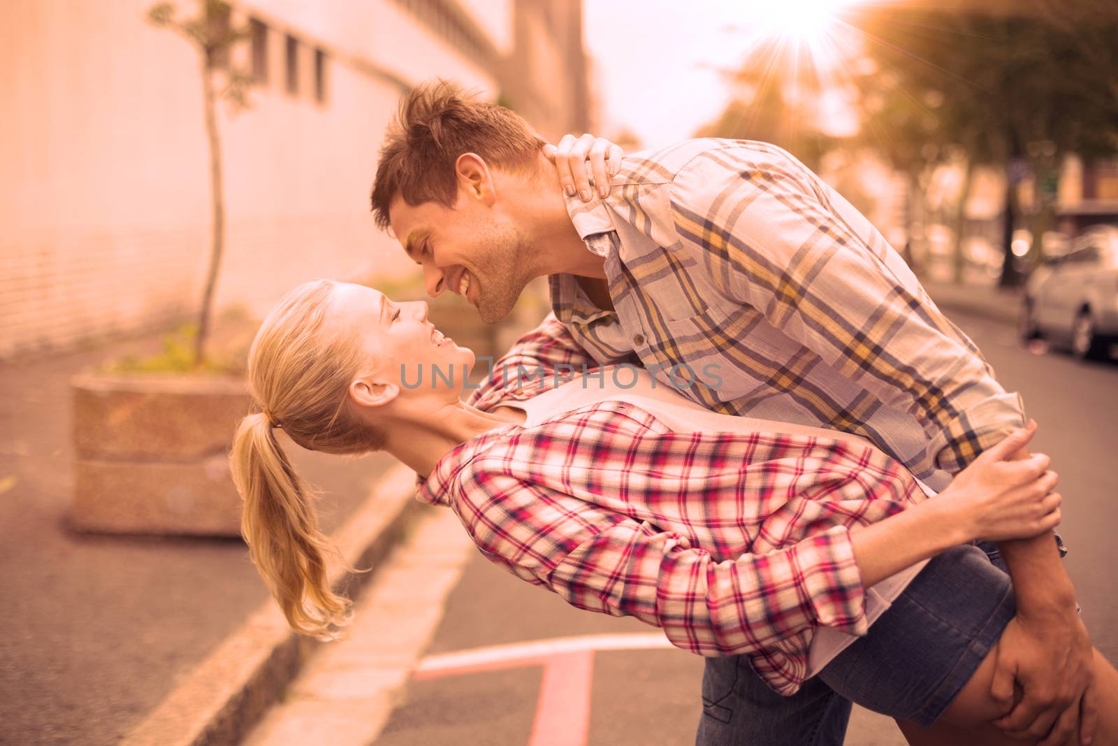 Hip romantic couple dancing in the street on a sunny day in the city