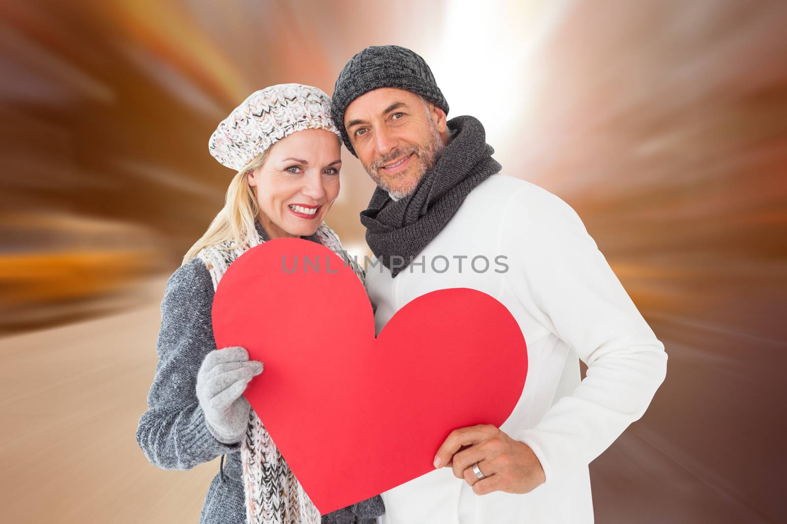 Smiling couple in winter fashion posing with heart shape against blurry new york street