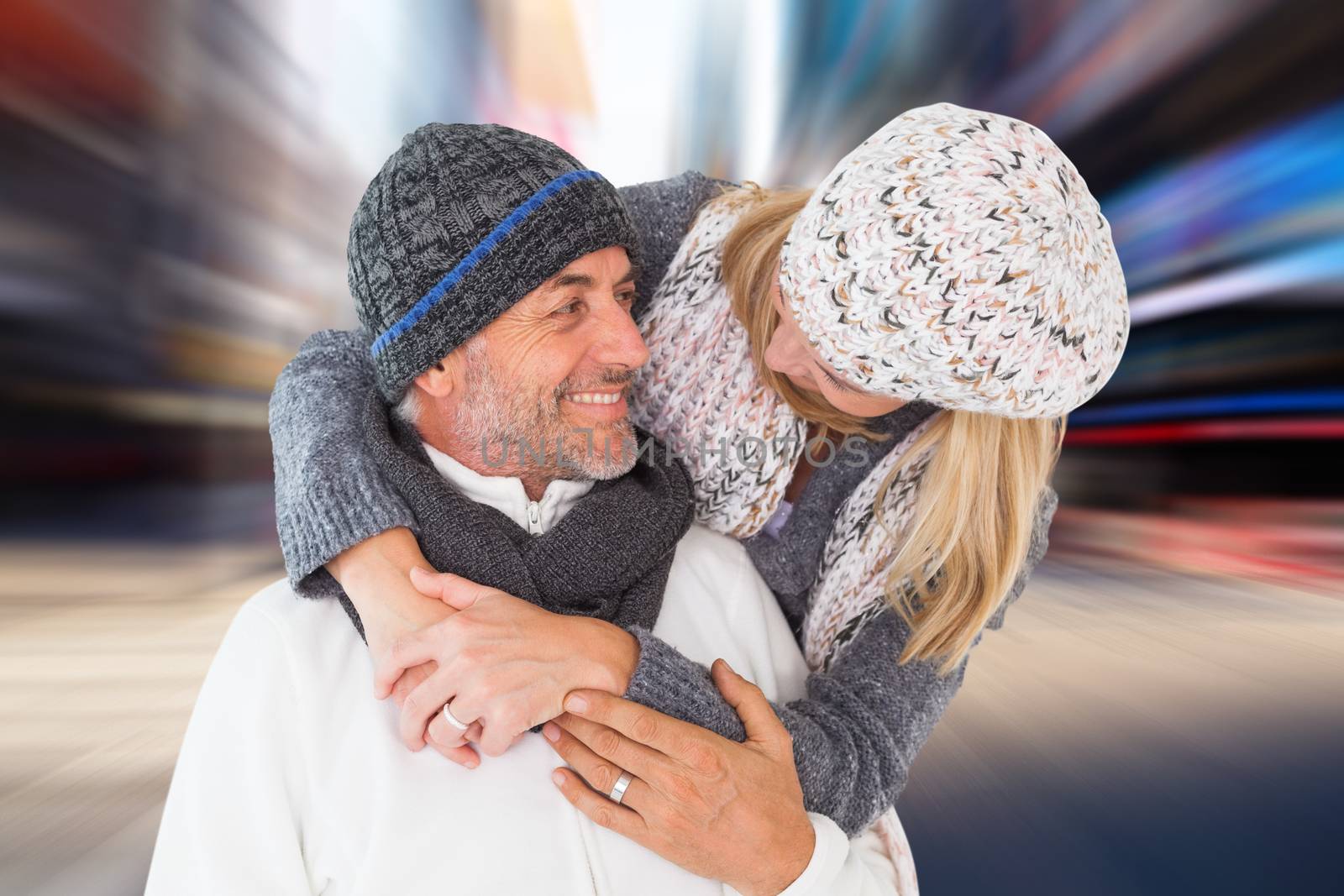 Happy couple in winter fashion embracing against blurry new york street