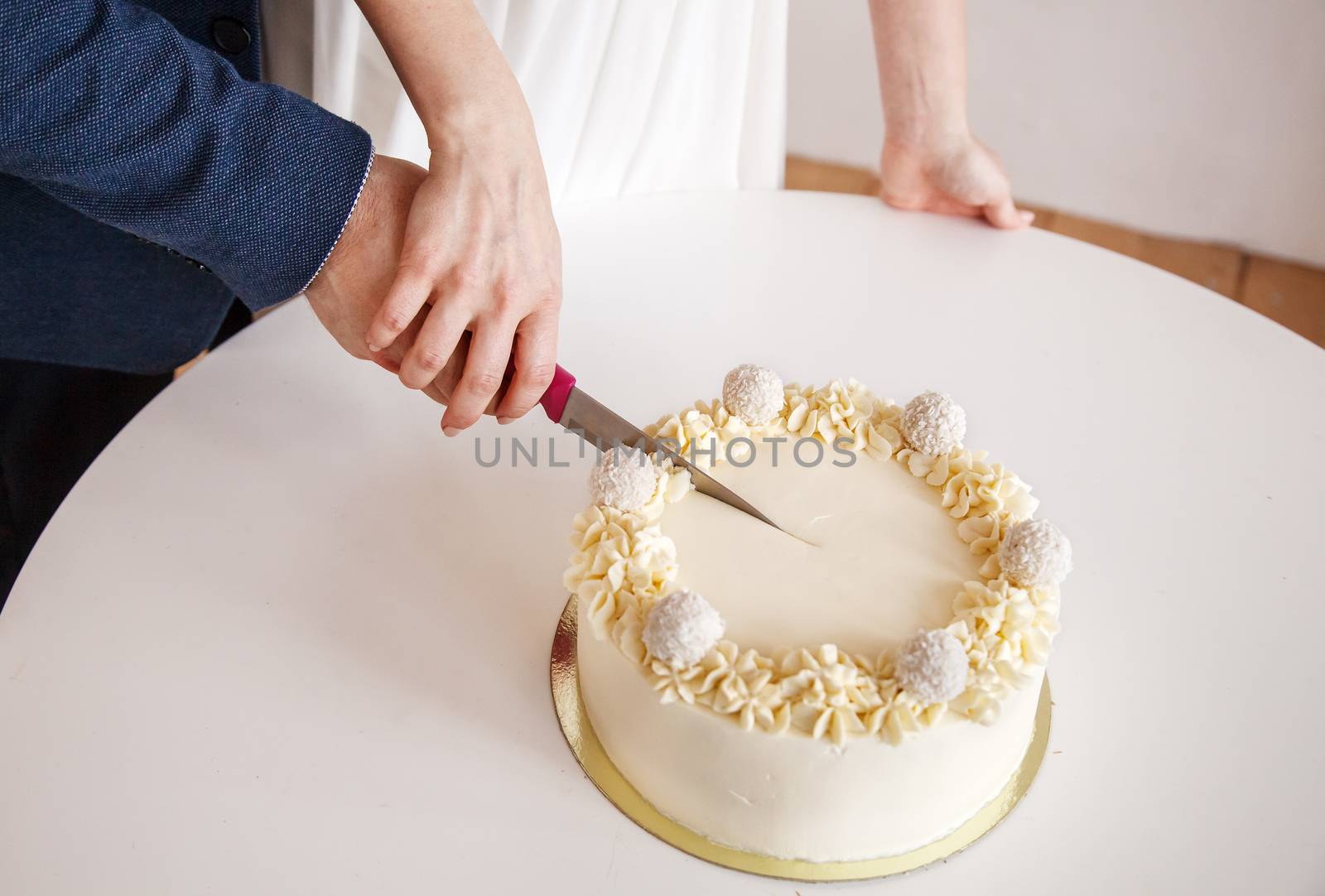 newlyweds cut the bridal cake. hands closeup