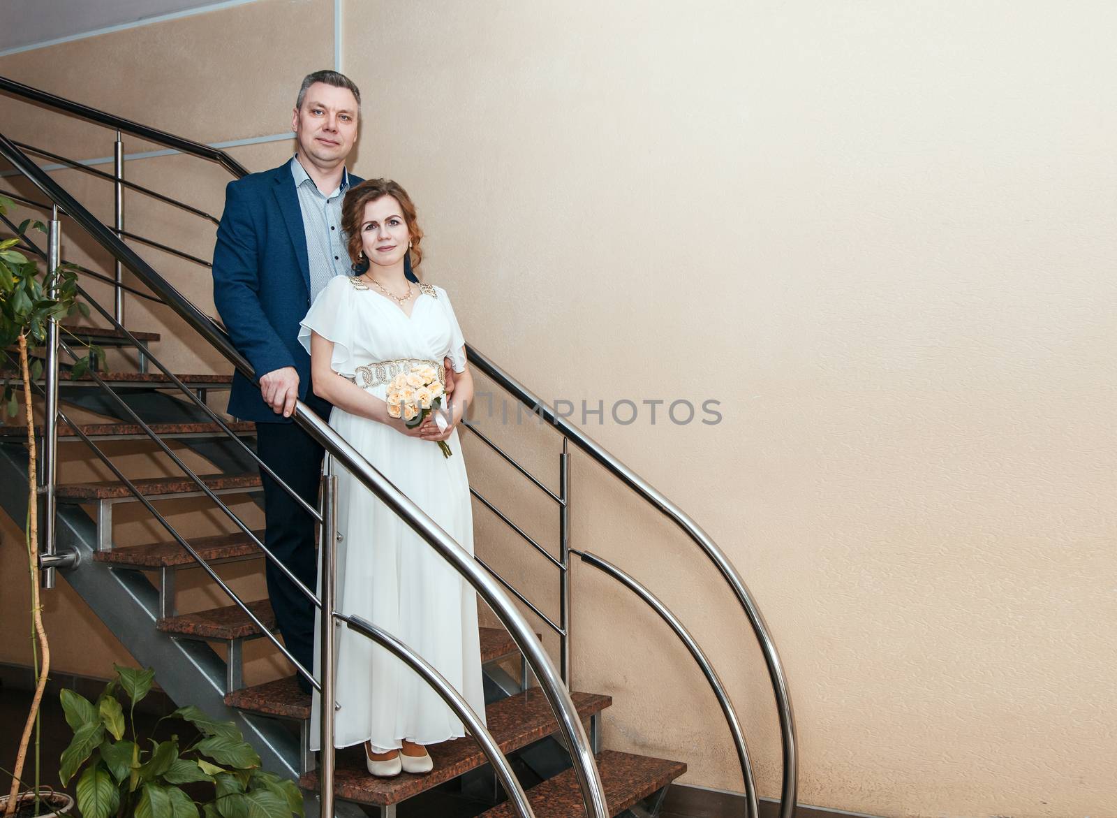couple of lovers standing on staircase in prefecture at marriage by raddnatt