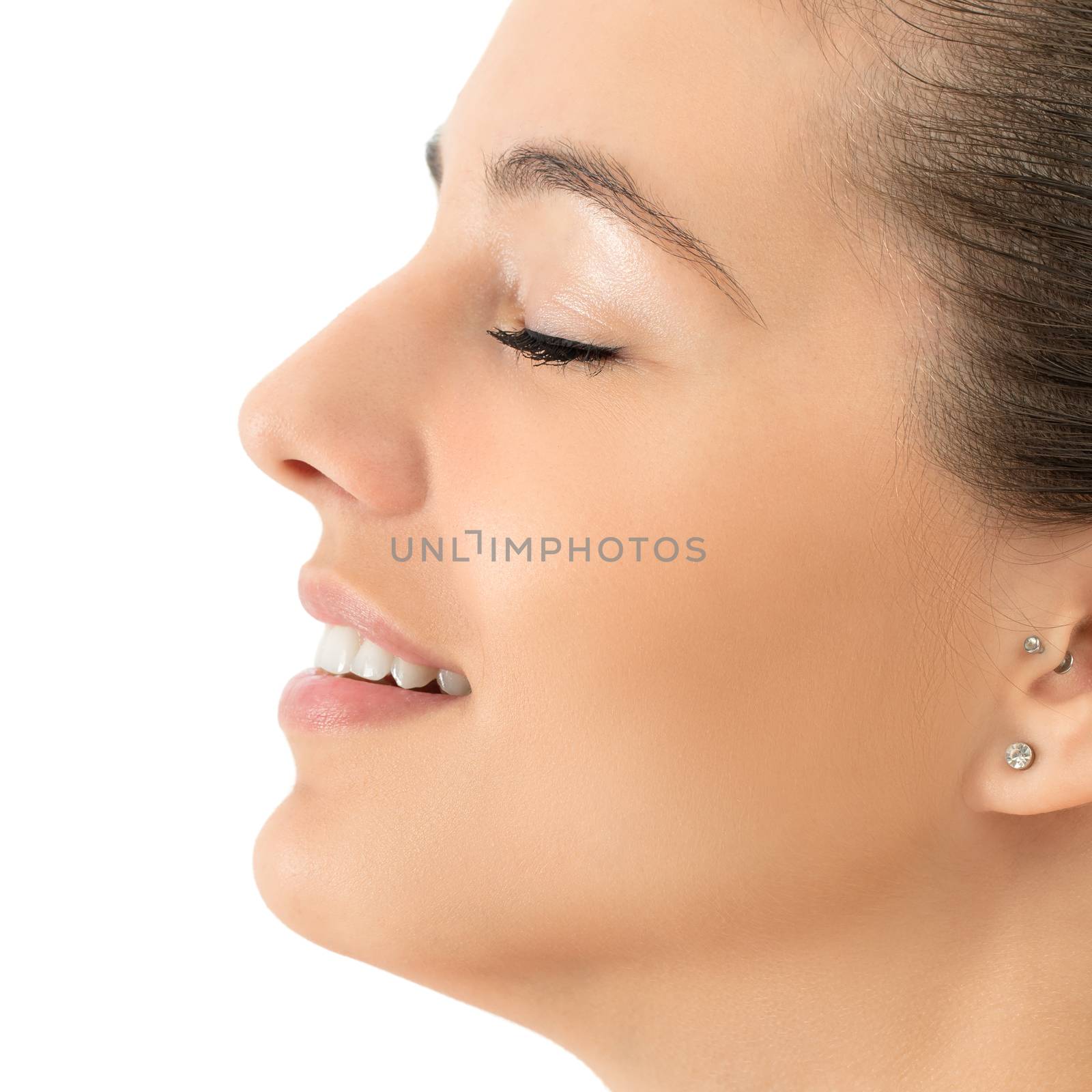 Macro close up side view beauty portrait of young woman smiling.Girl with eyes closed isolated against white background.