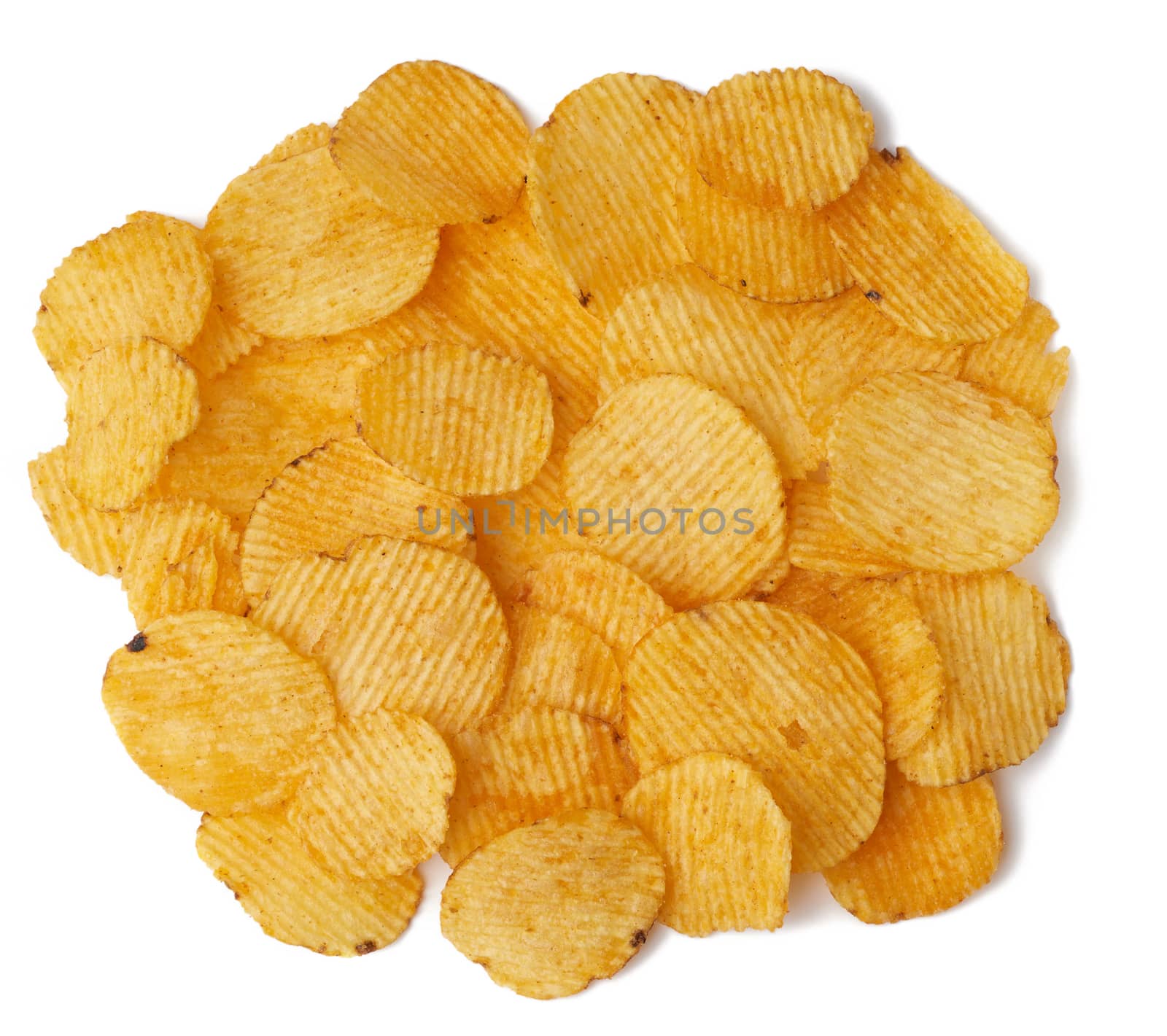 heap of corrugated round yellow fried potato chips isolated on white background, food with spice, top view