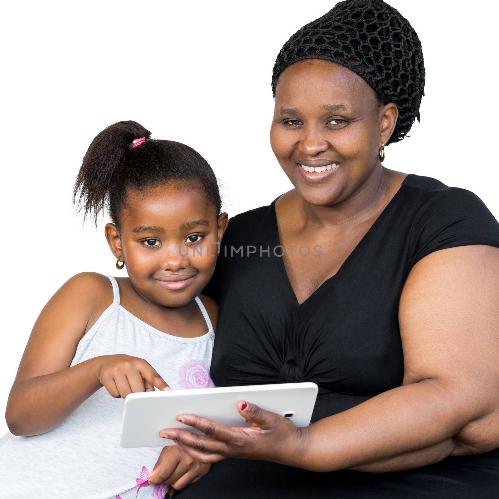Close up portrait of little african girl and mother holding digital tablet isolated on white background.Mother and daughter looking at camera.