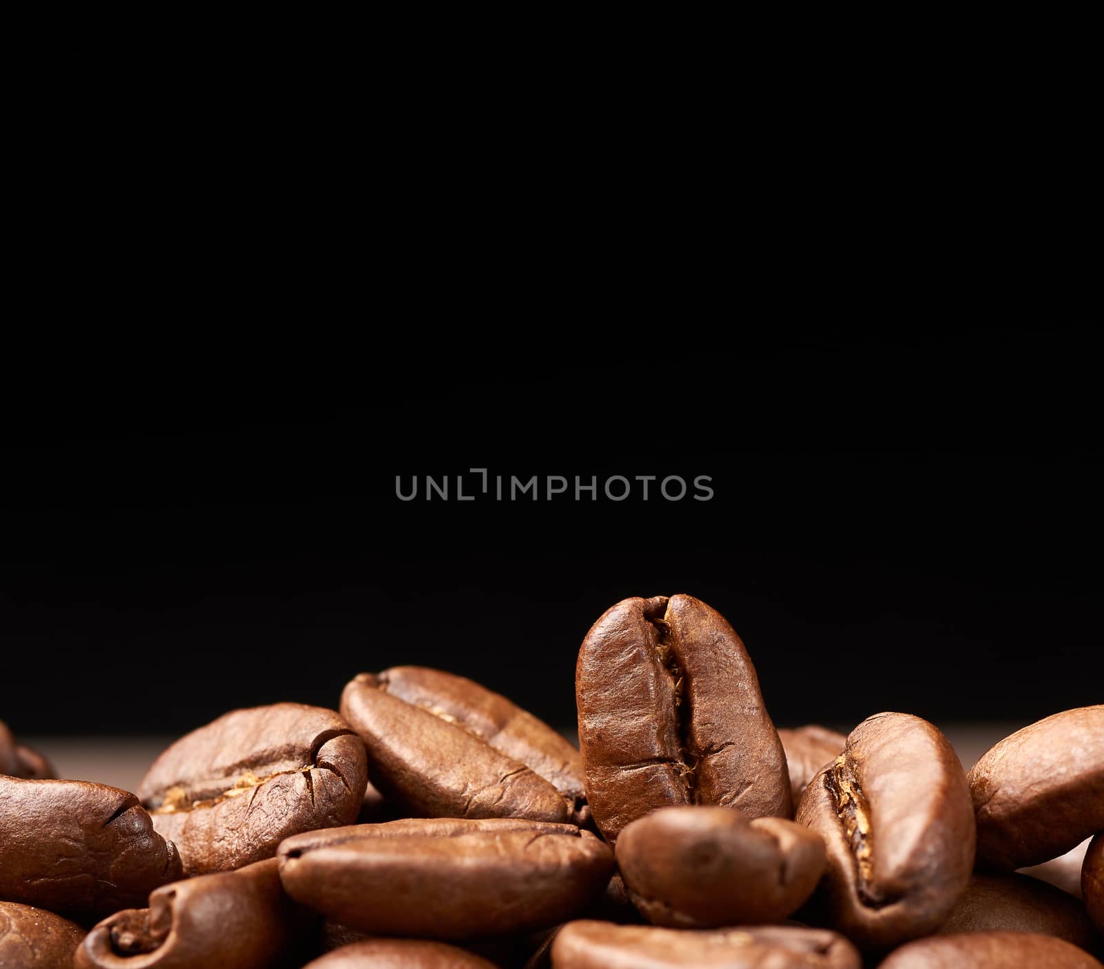 fried grains Brazil Santos, grade of Brazilian arabica on a black background, selective focus, close up