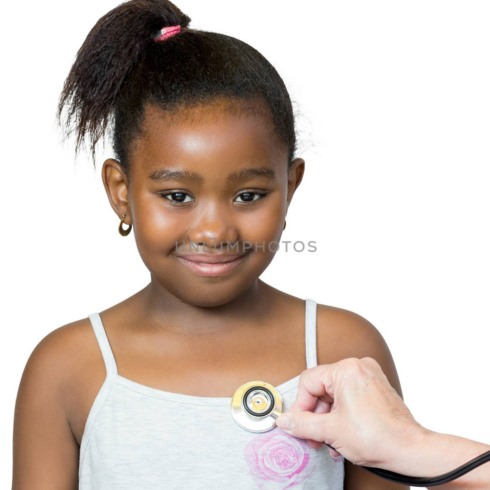 Close up portrait of cute little african girl having heartbeat taken.Hand positioning stethoscope against chest.Isolated on white background.