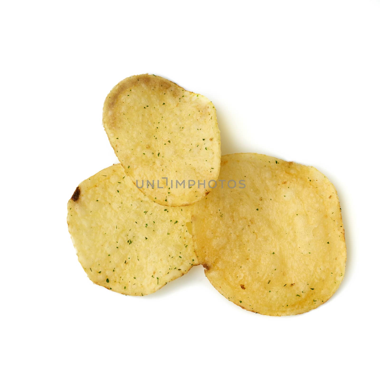 round yellow fried potato chips with dill, food with spice, top view