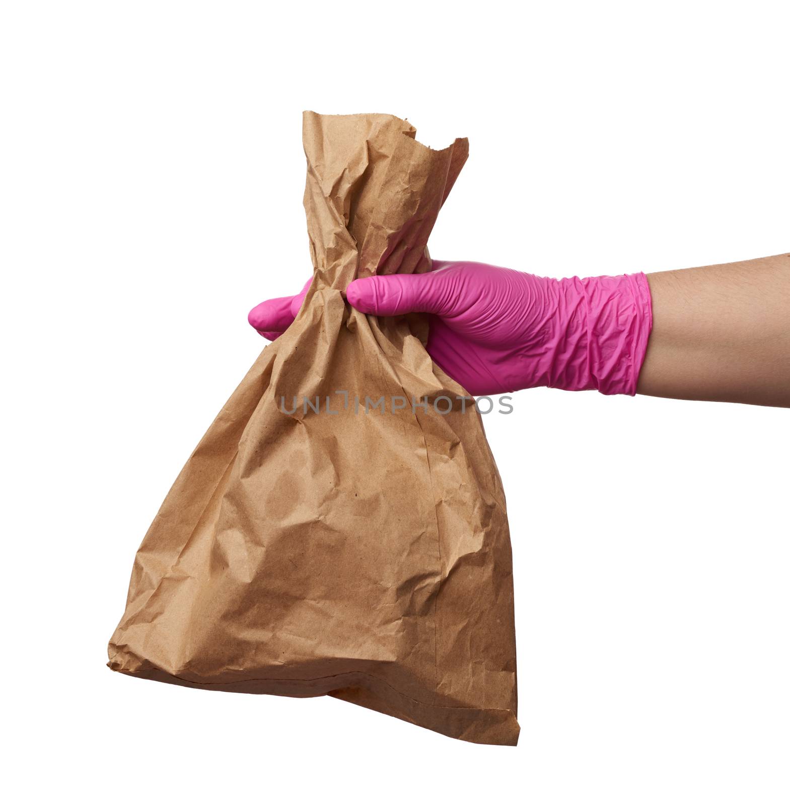 hand in a pink latex glove holds a full paper bag of brown craft paper, concept of remote and contactless food delivery, safe receipt of orders, white background