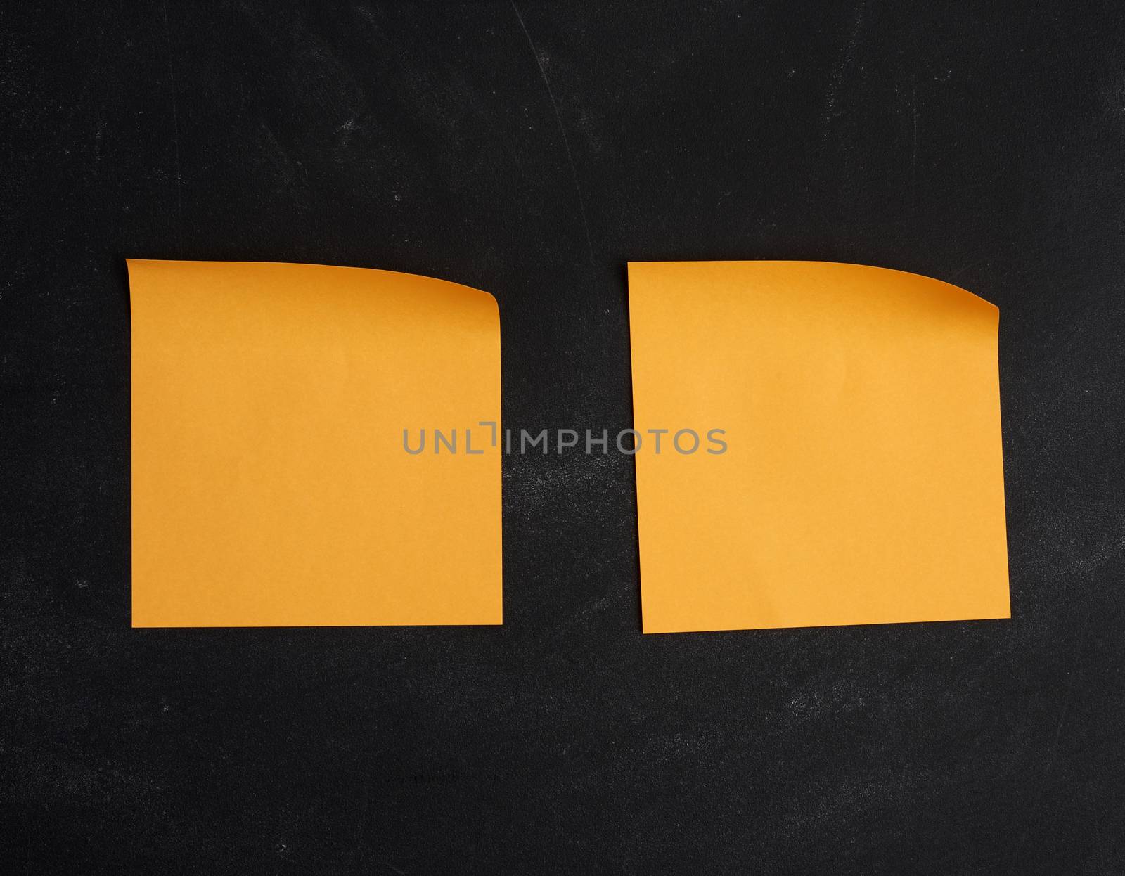 blank orange paper sticker glued on a black board by ndanko
