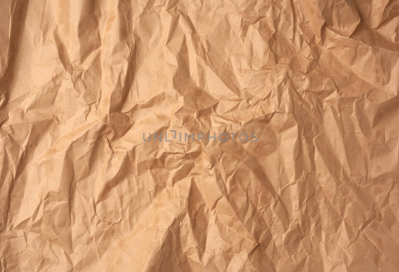crumpled blank sheet of brown wrapping kraft paper, vintage text by ndanko