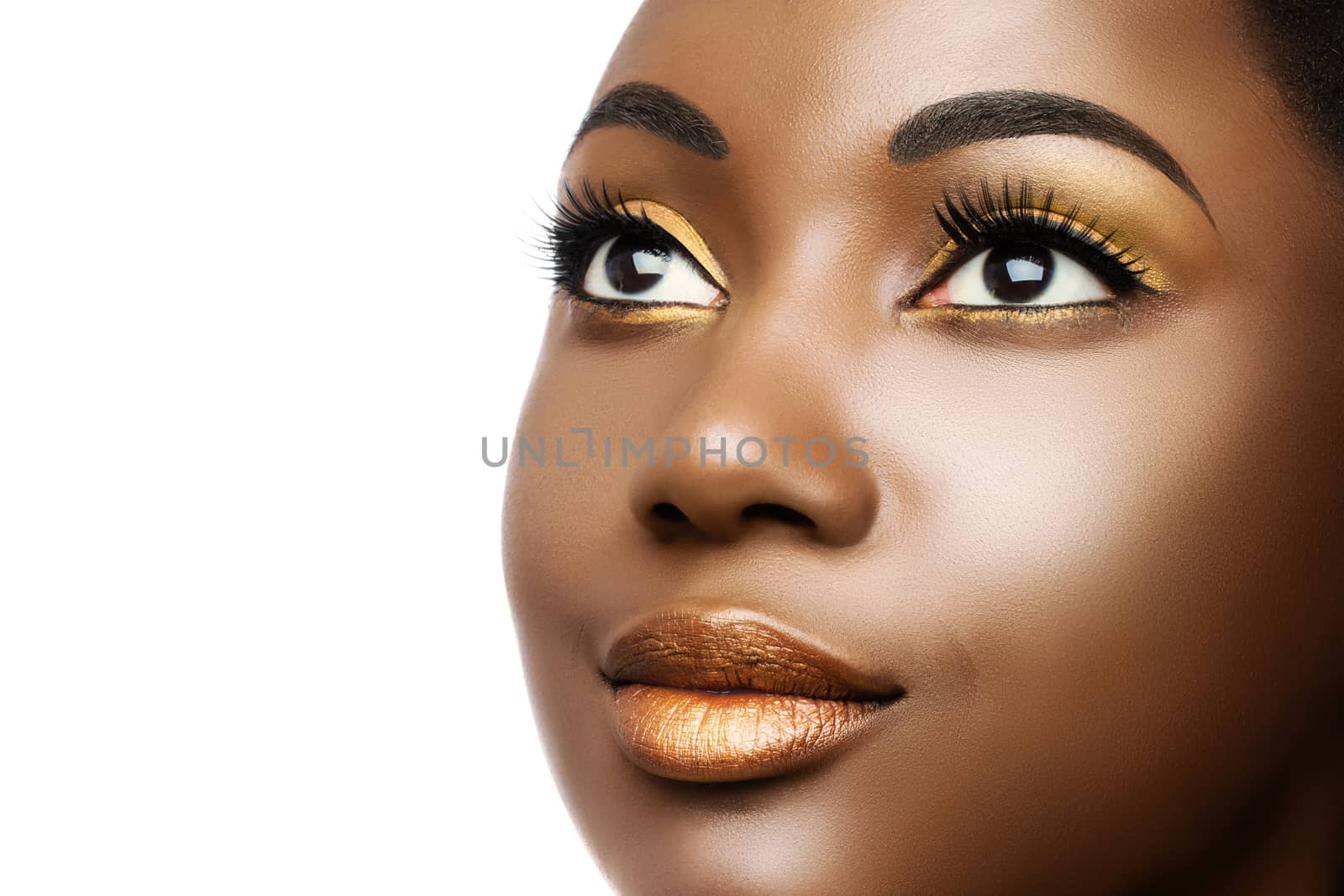 Macro close up cosmetic beauty portrait of young black woman.Girl wearing professional make up isolated on white background.