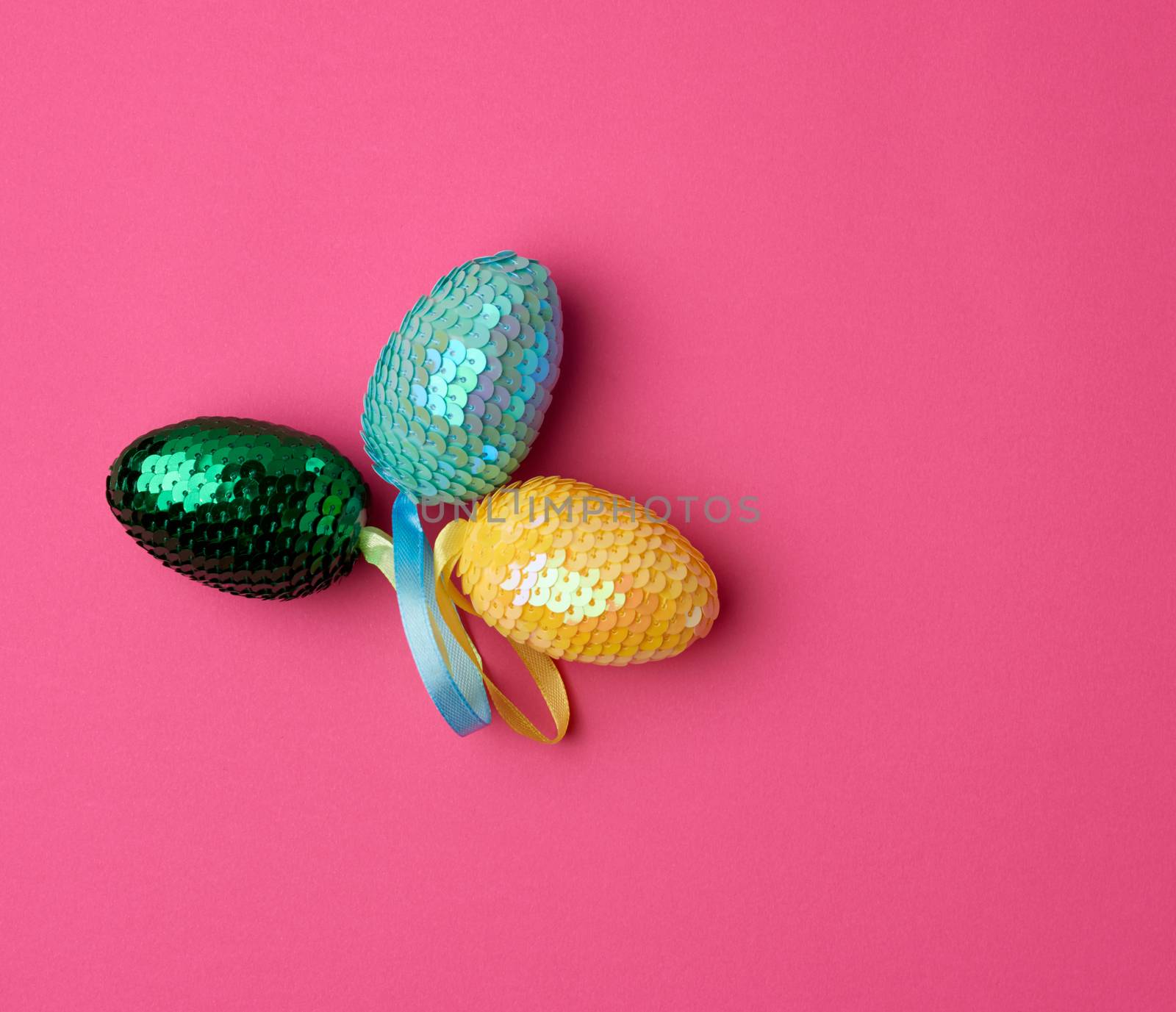multicolored decorative Easter eggs decorated with sequins on a  by ndanko