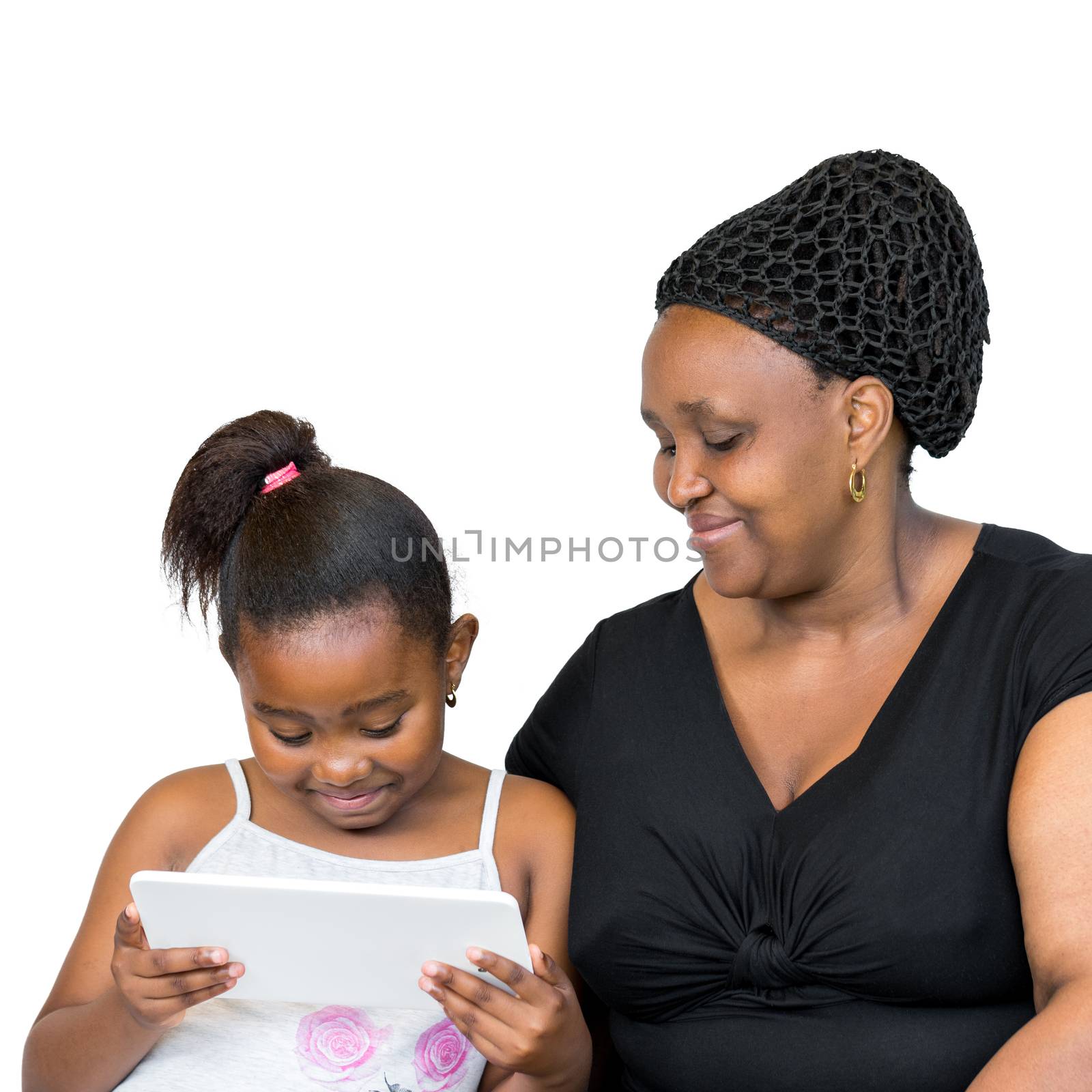 Close up portrait of little african girl with mother isolated on white background.Mother and daughter looking together at digital tablet.