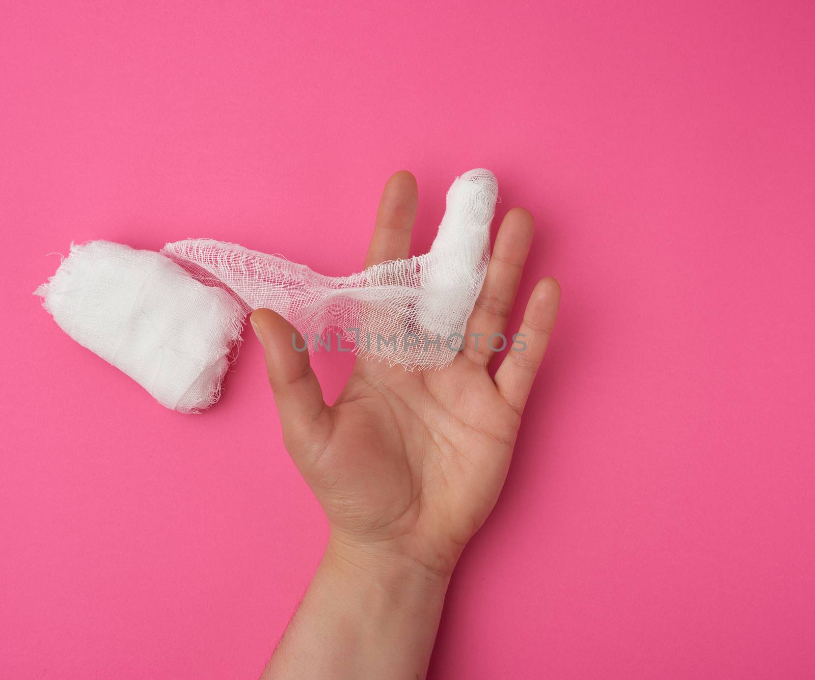 rewound middle finger with white medical sterile gauze bandage by ndanko